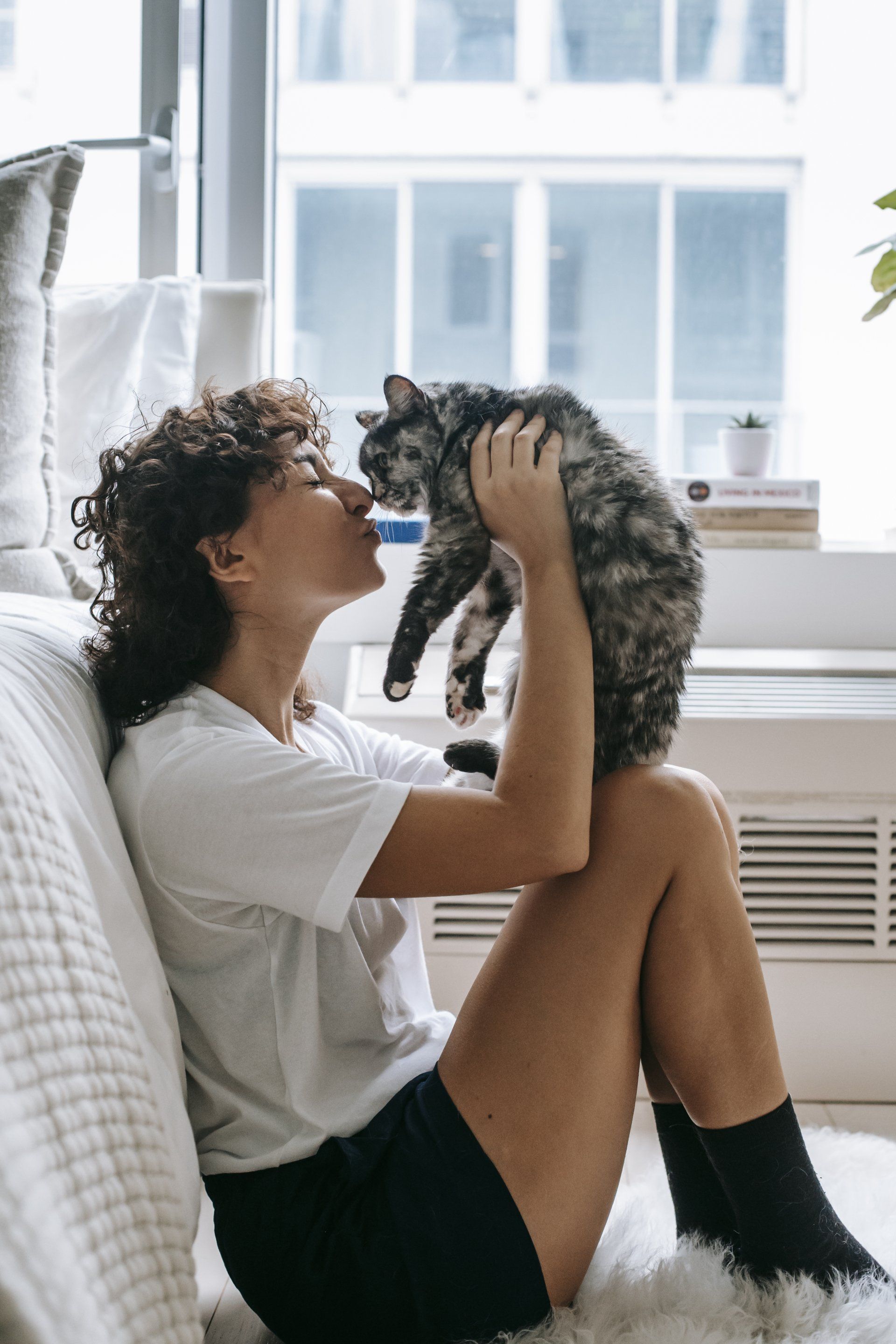 Person holding a cat, representing pet-friendly apartments at Unique Apartment Homes