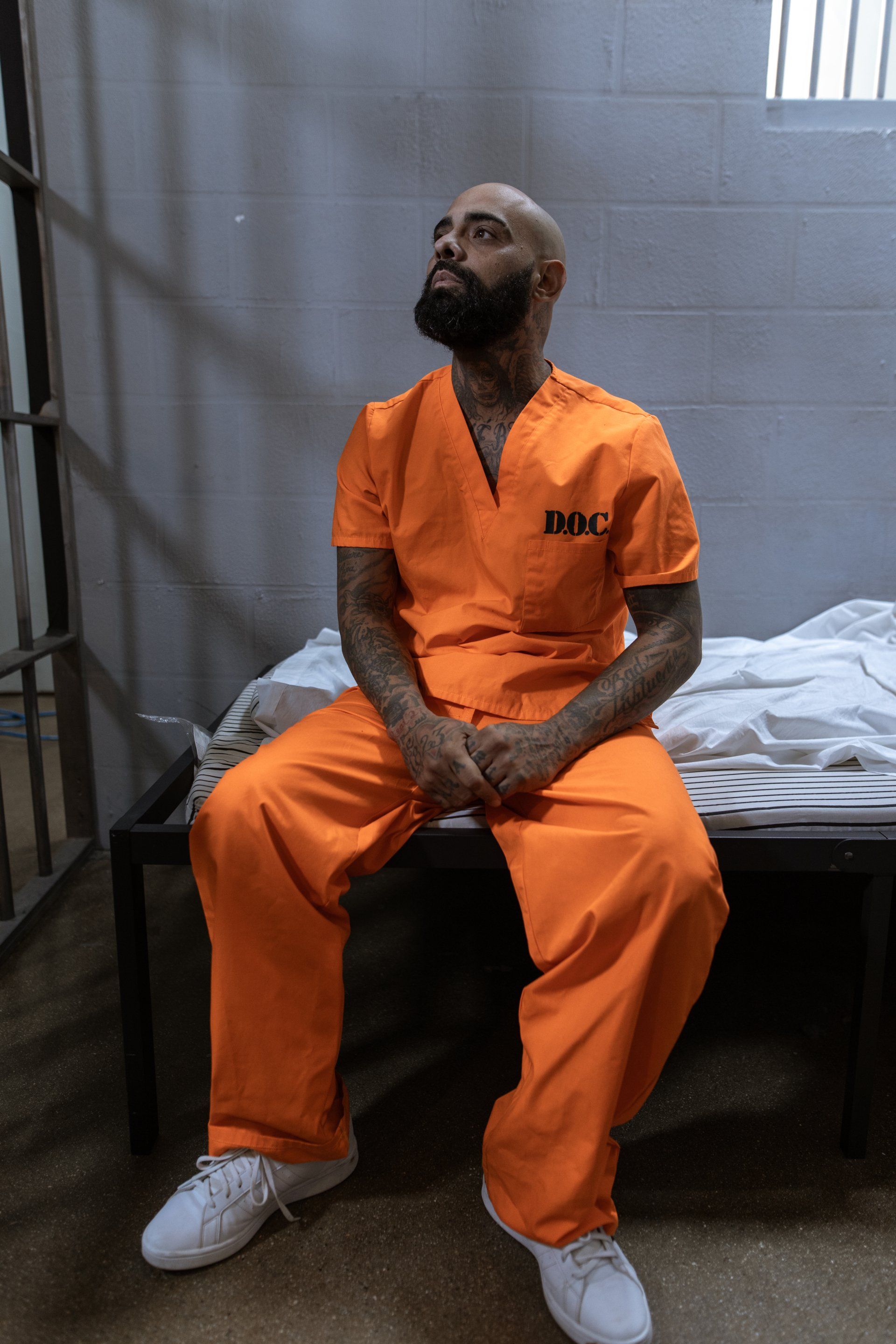 Prisoner in a prisoner cell Prisoner sitting in a prison on bunk