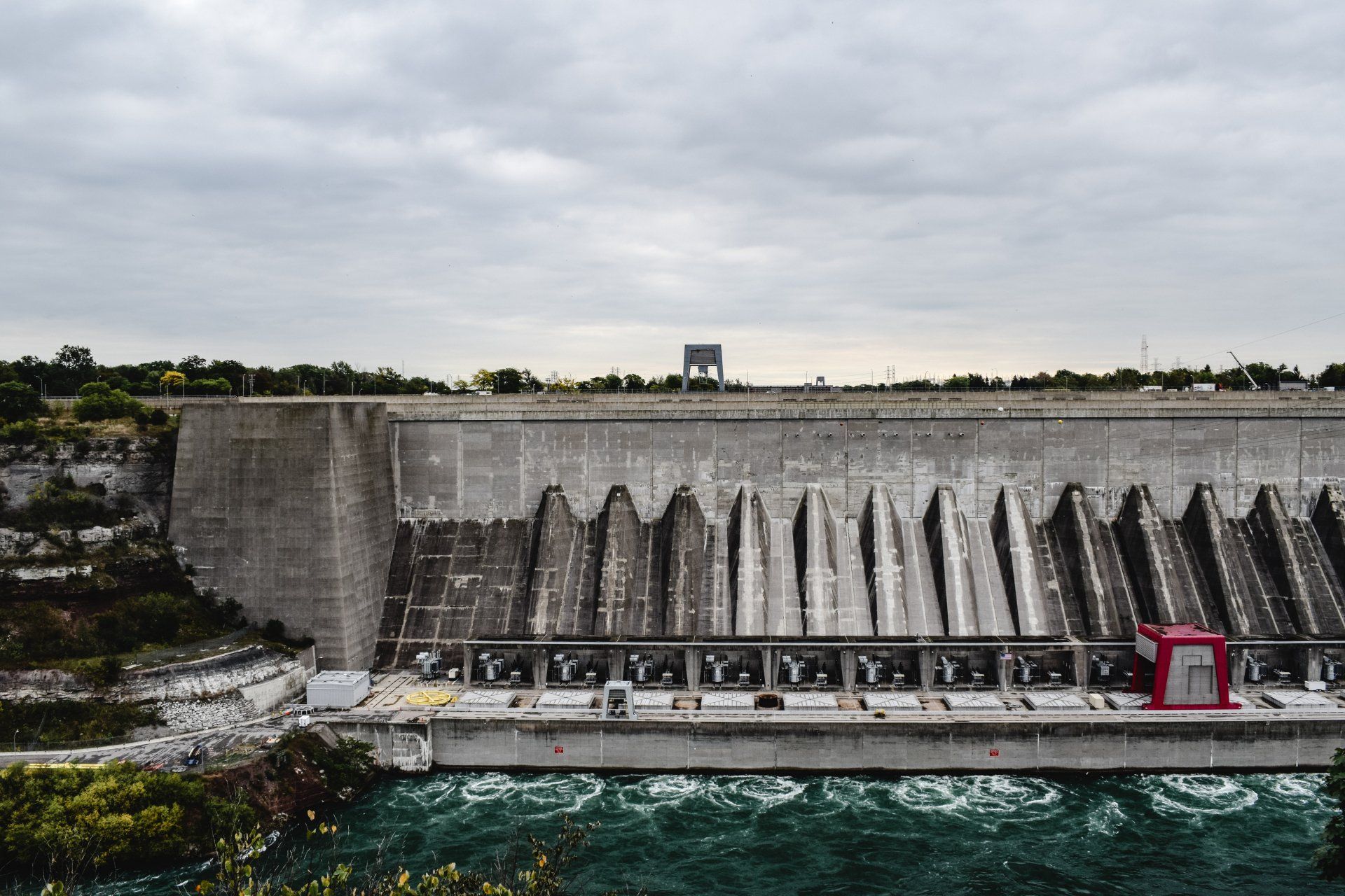 An aerial view of a large dam surrounded by water.