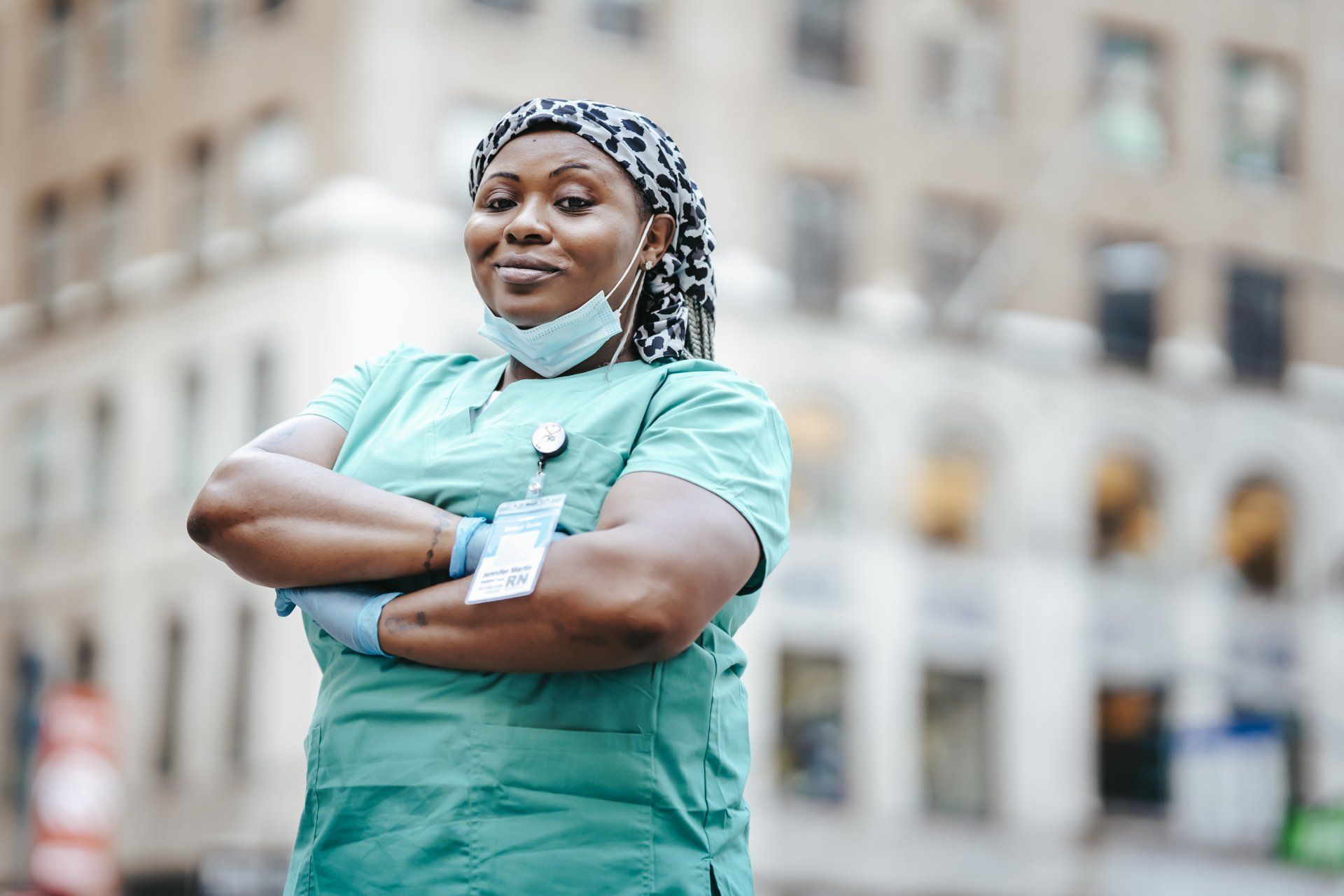 Nurse standing confidently outside