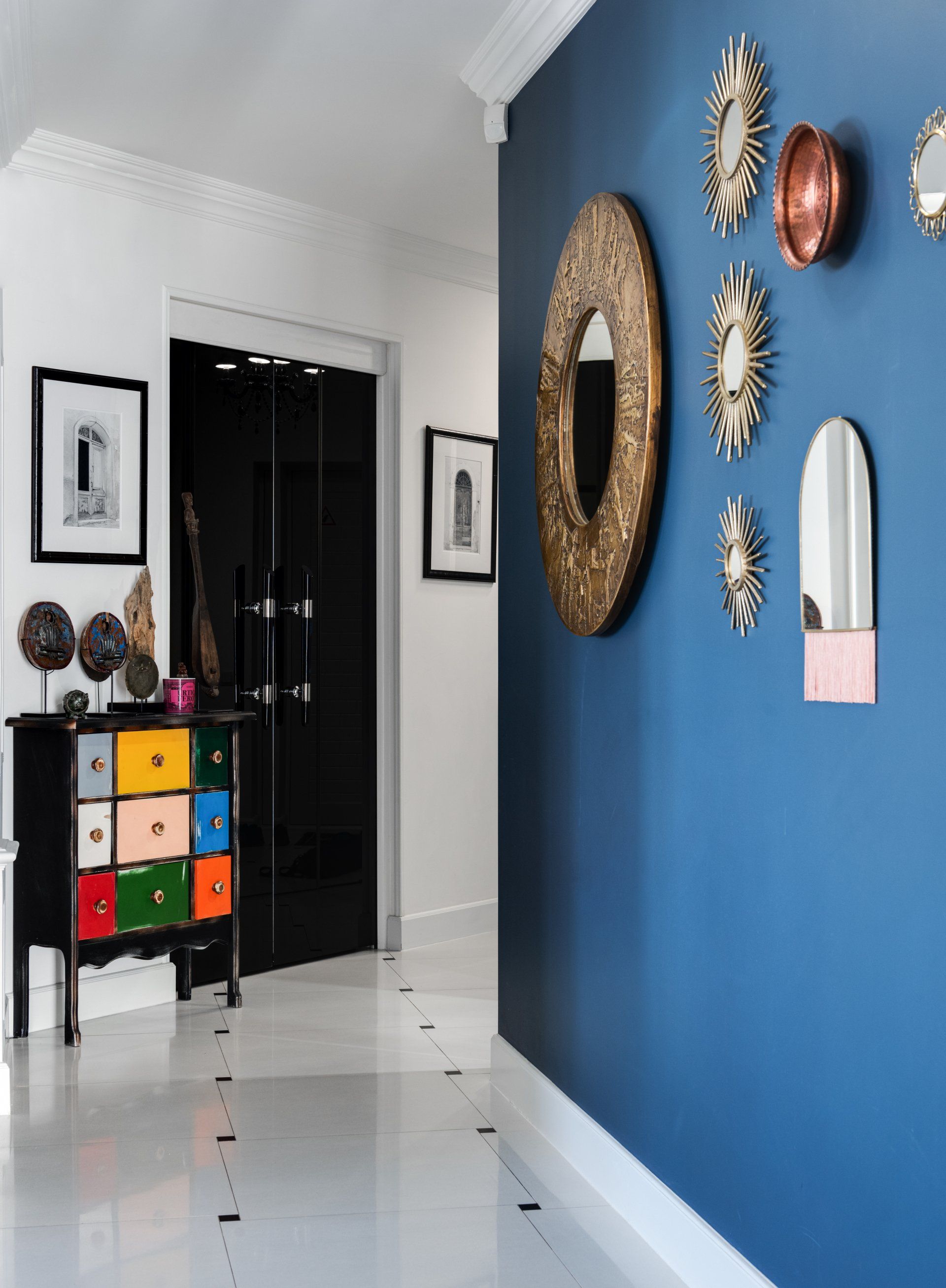 a hallway with white and blue accent paint