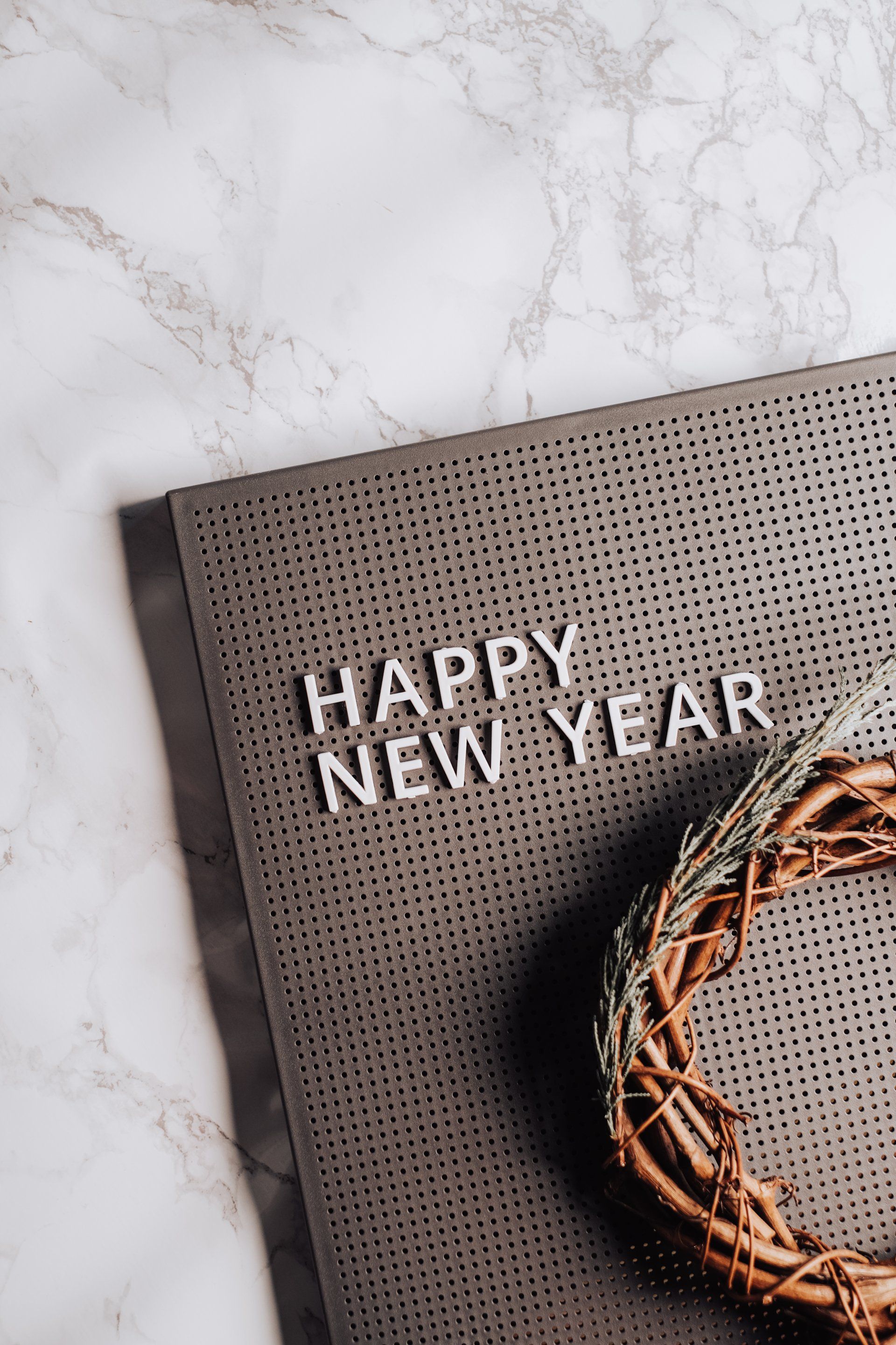 A happy new year card with a wreath on top of it.