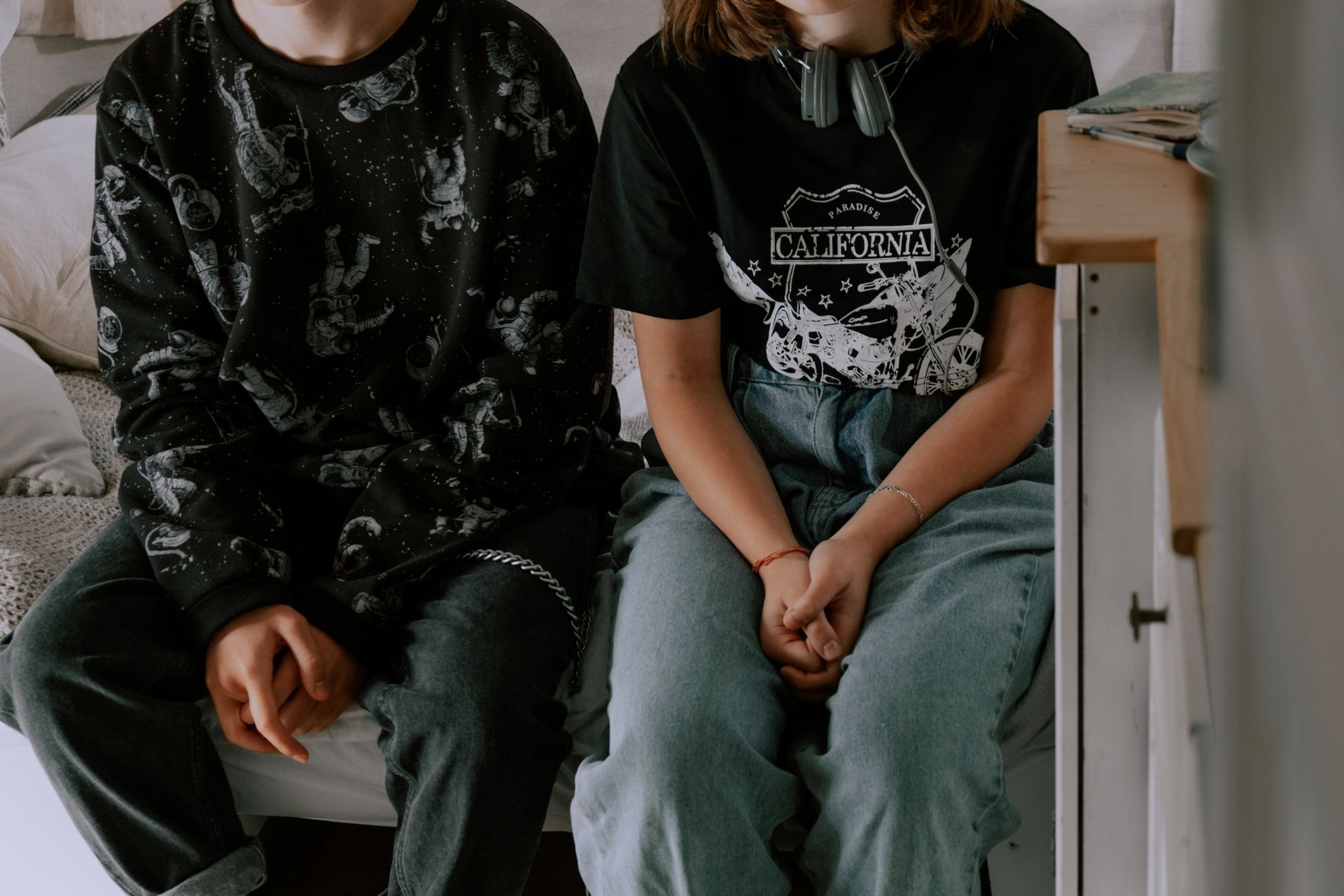 A boy and a girl are sitting next to each other on a couch.