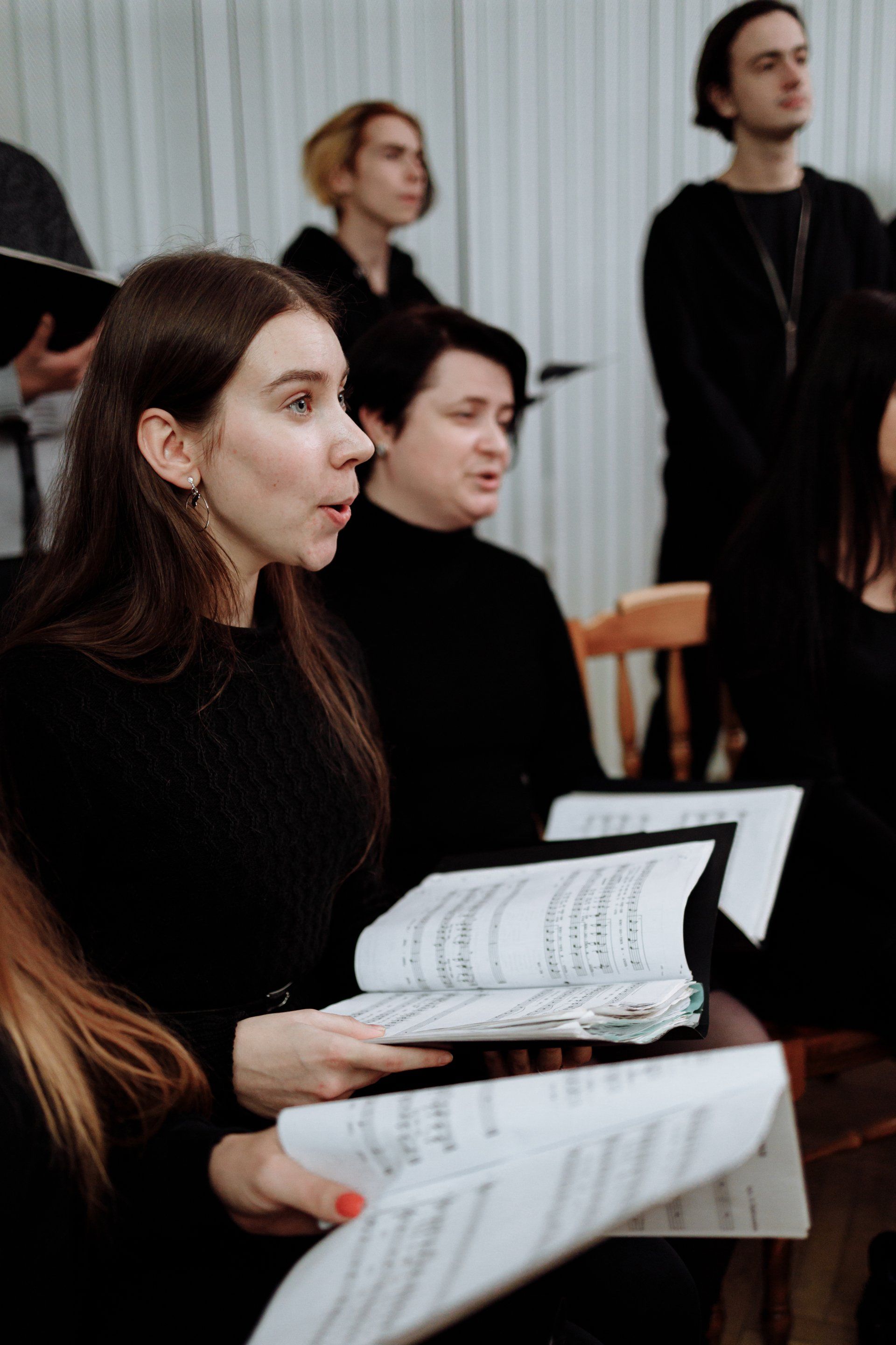 A group of people are singing in a choir.