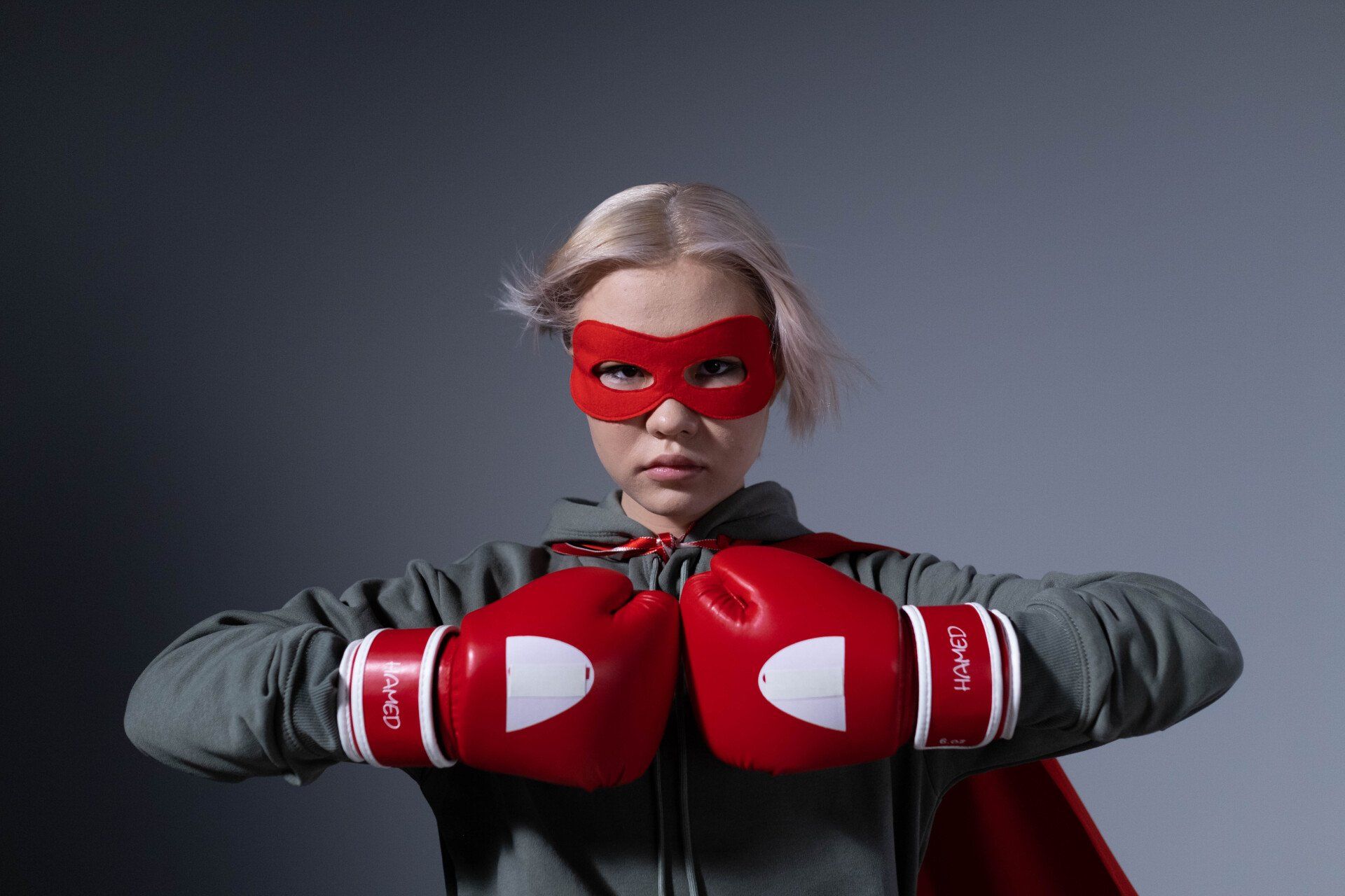 Girl with red hero mask and red boxing gloves.