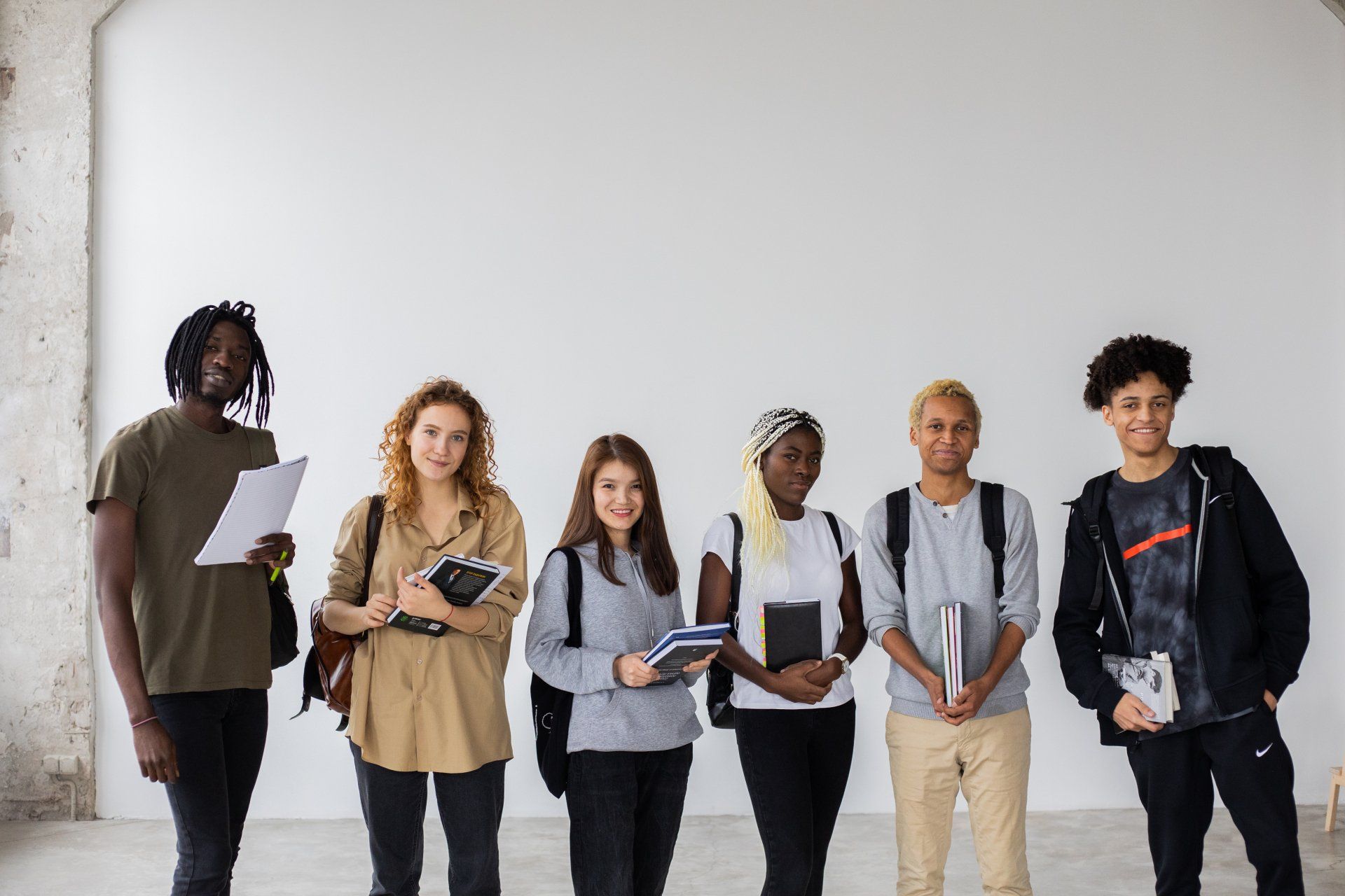 a group of people standing next to each other with one wearing a nike shirt