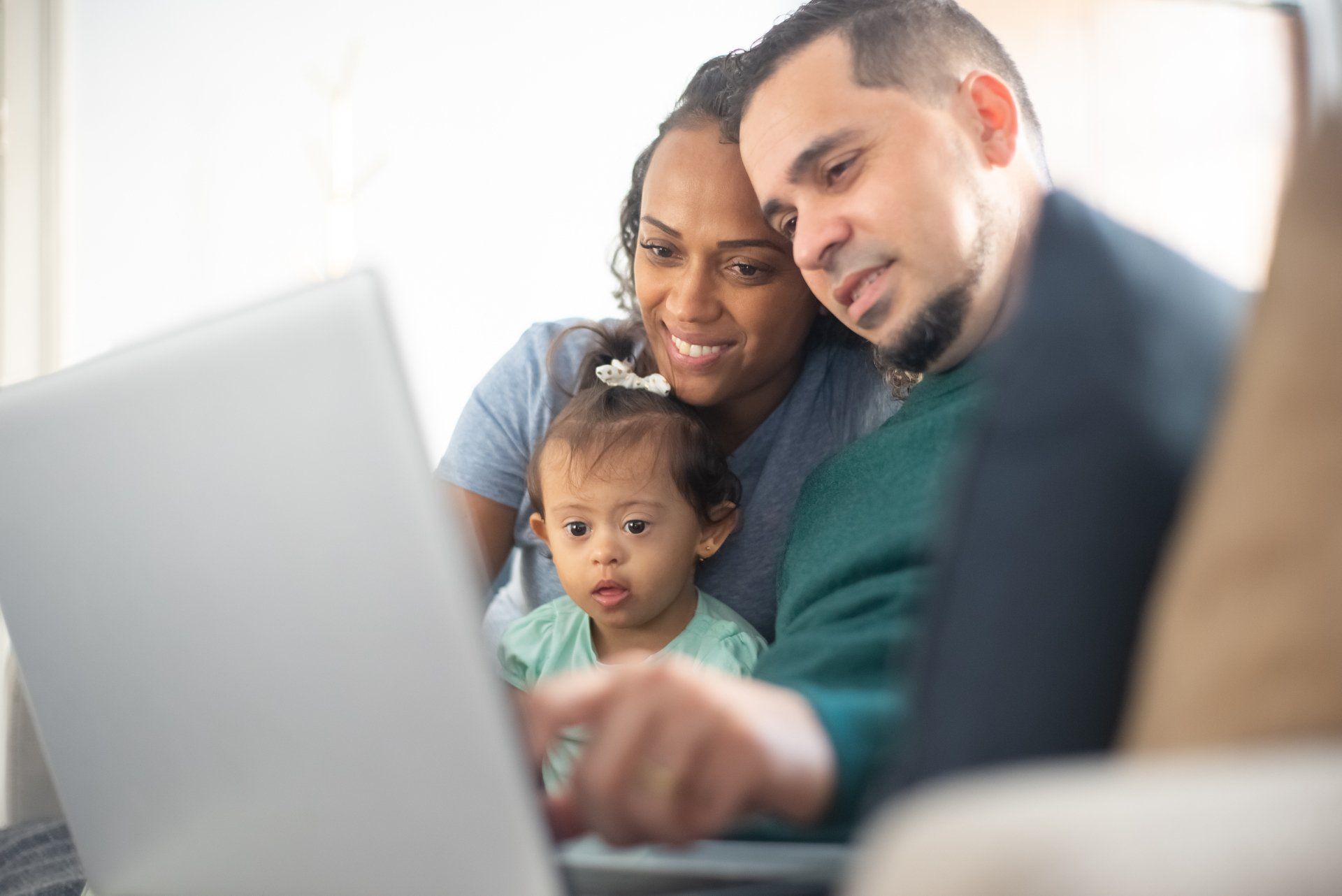 Family looking online for Family Support Services with their young child.