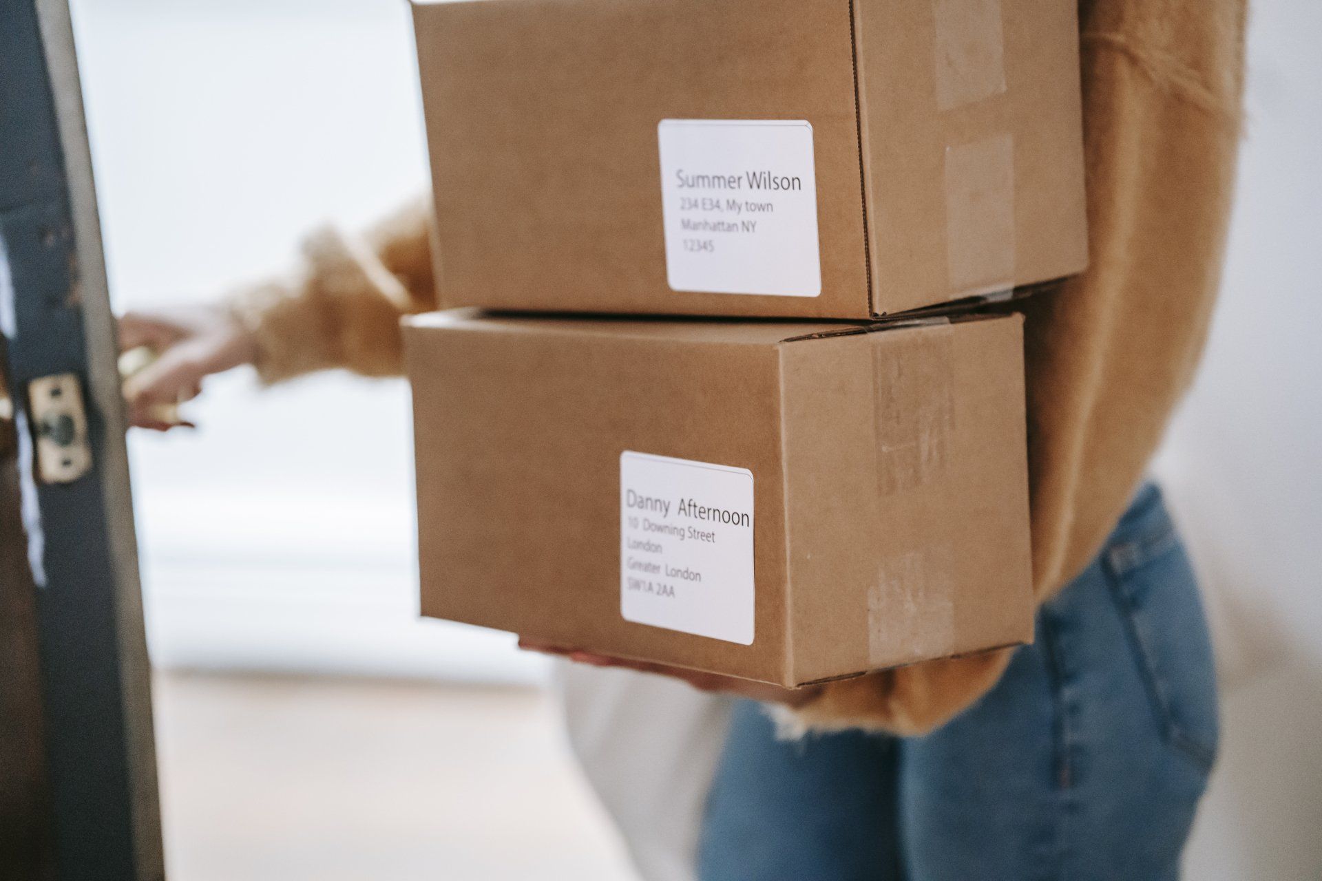 An image of a person holding packages for delivery.