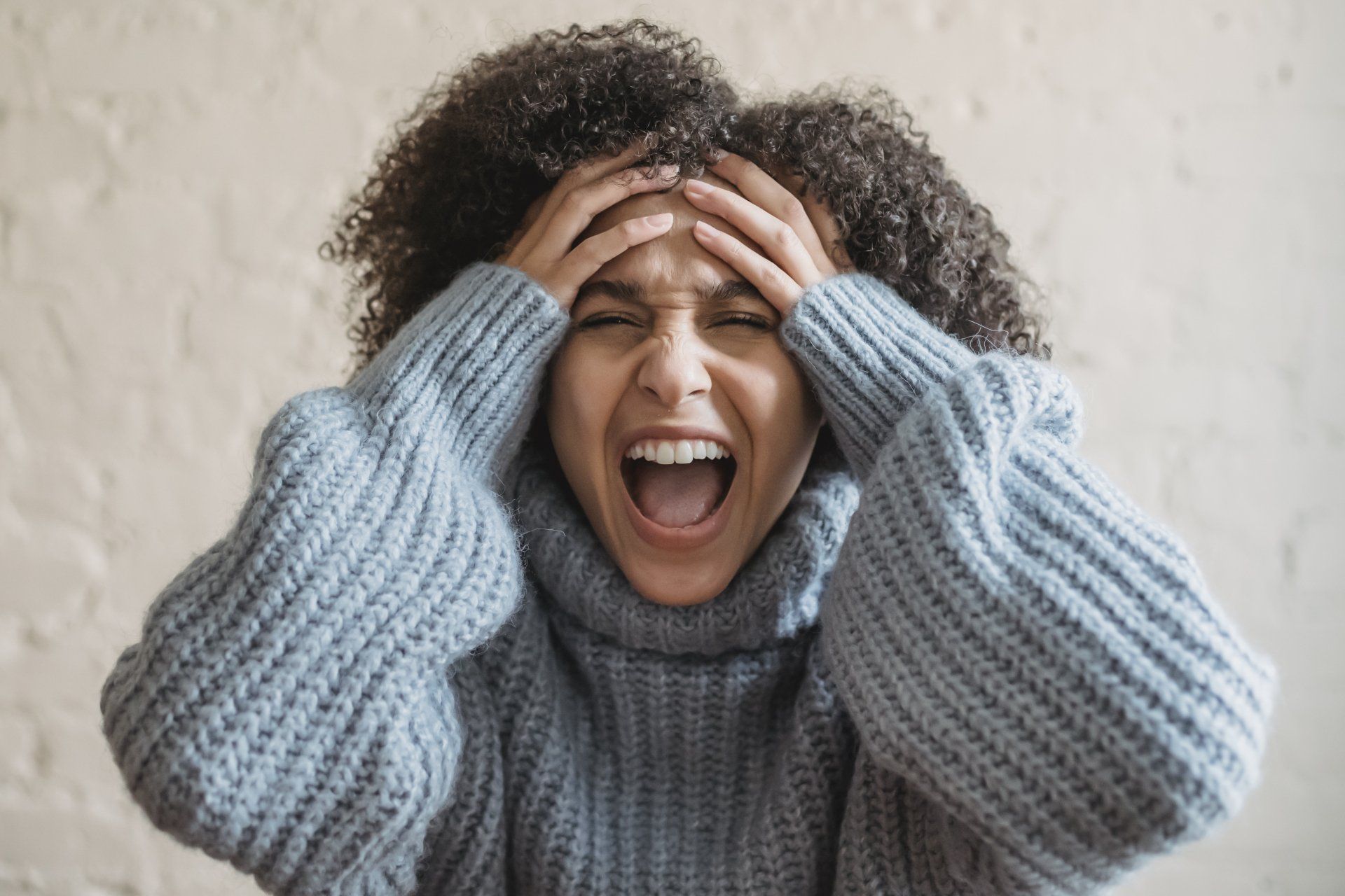 Stressed woman with head in her hands