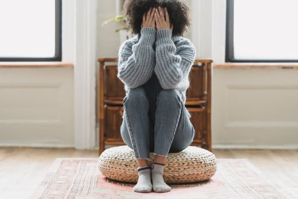 An image of a woman sitting alone suffering depression at Imperial Psychiatric Services in DE