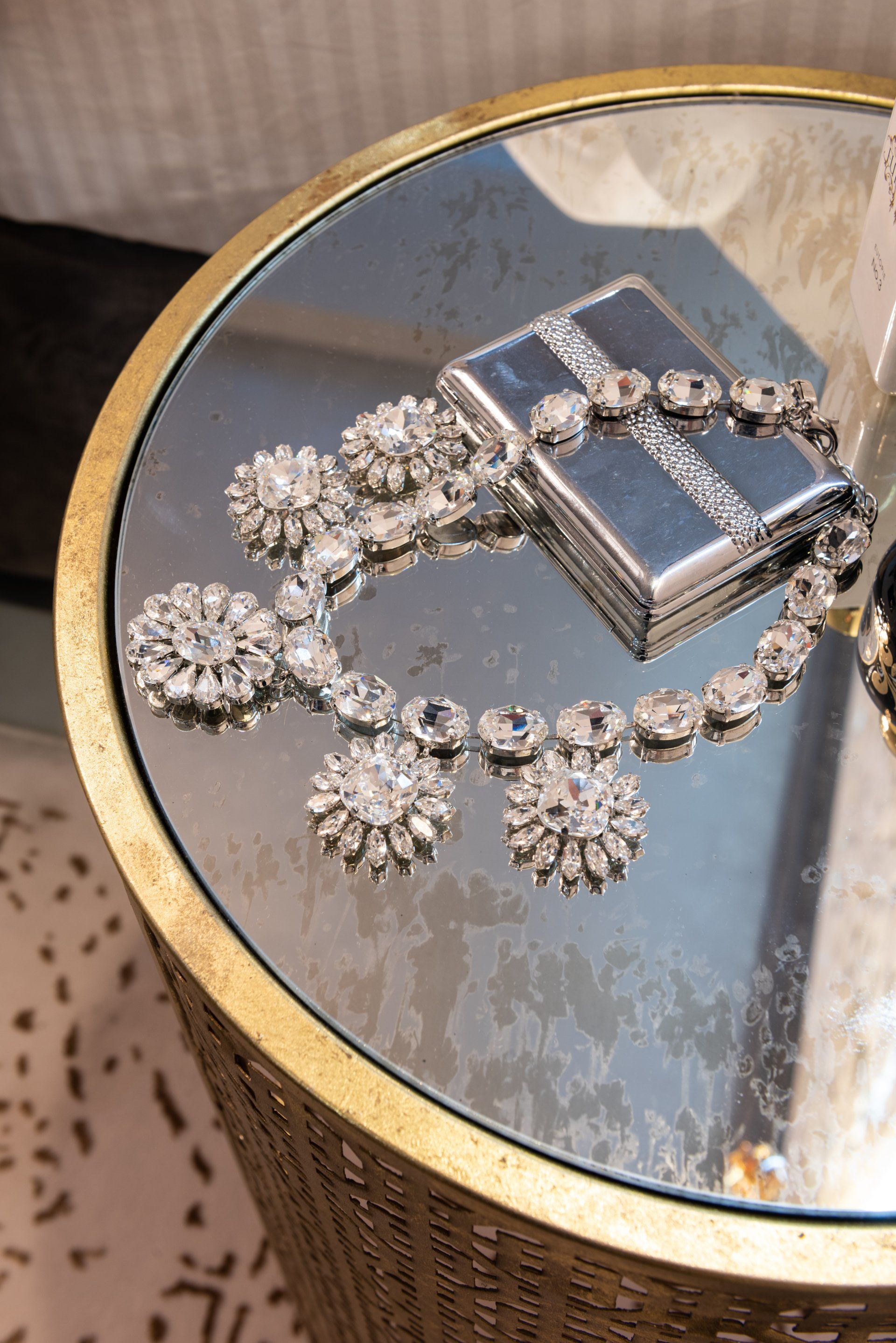 A table with a necklace and a purse on it