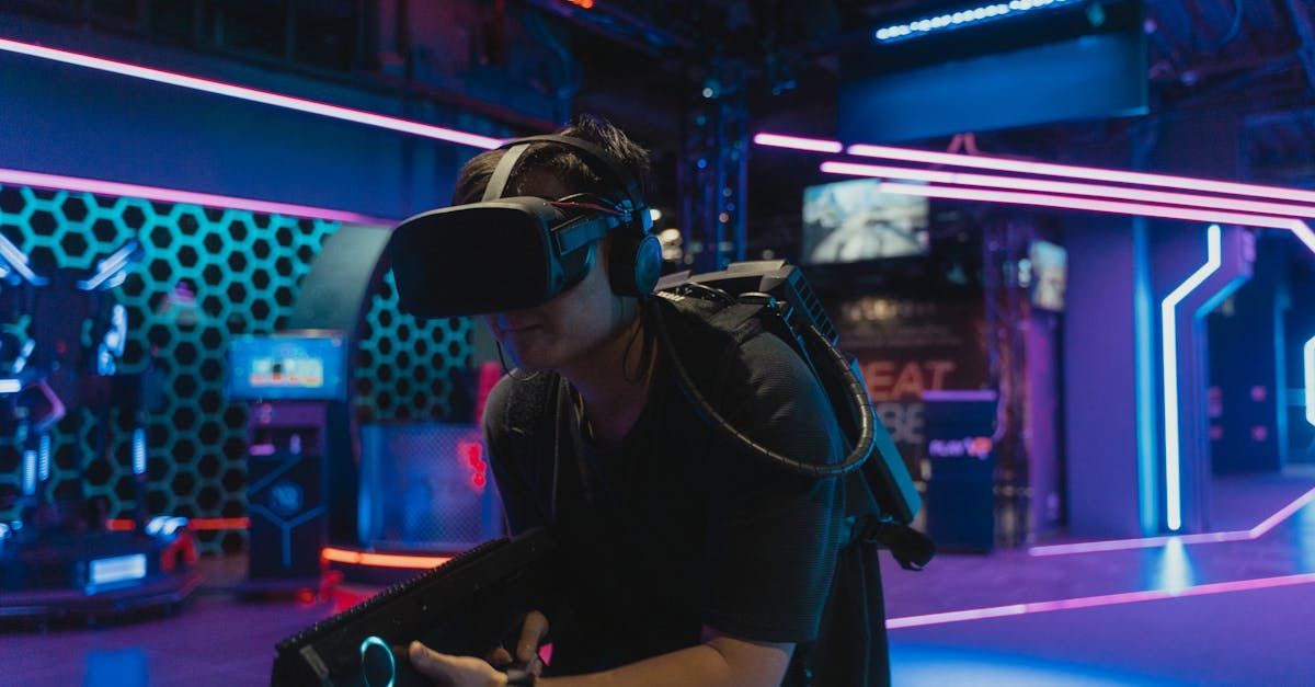 Person wearing VR headset and backpack, holding a gun, in a brightly lit game arcade.