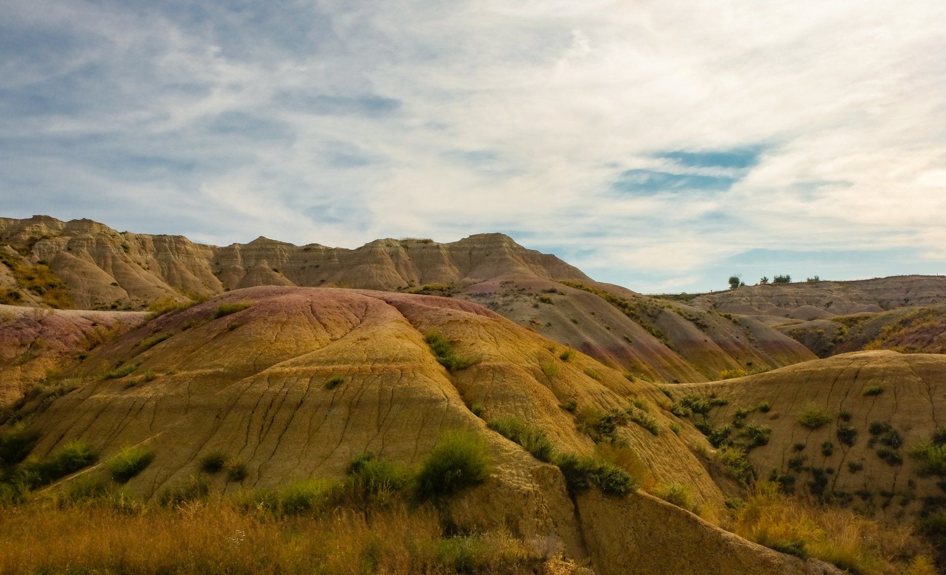 A landscape of a mountain range with a blue sky in the background.