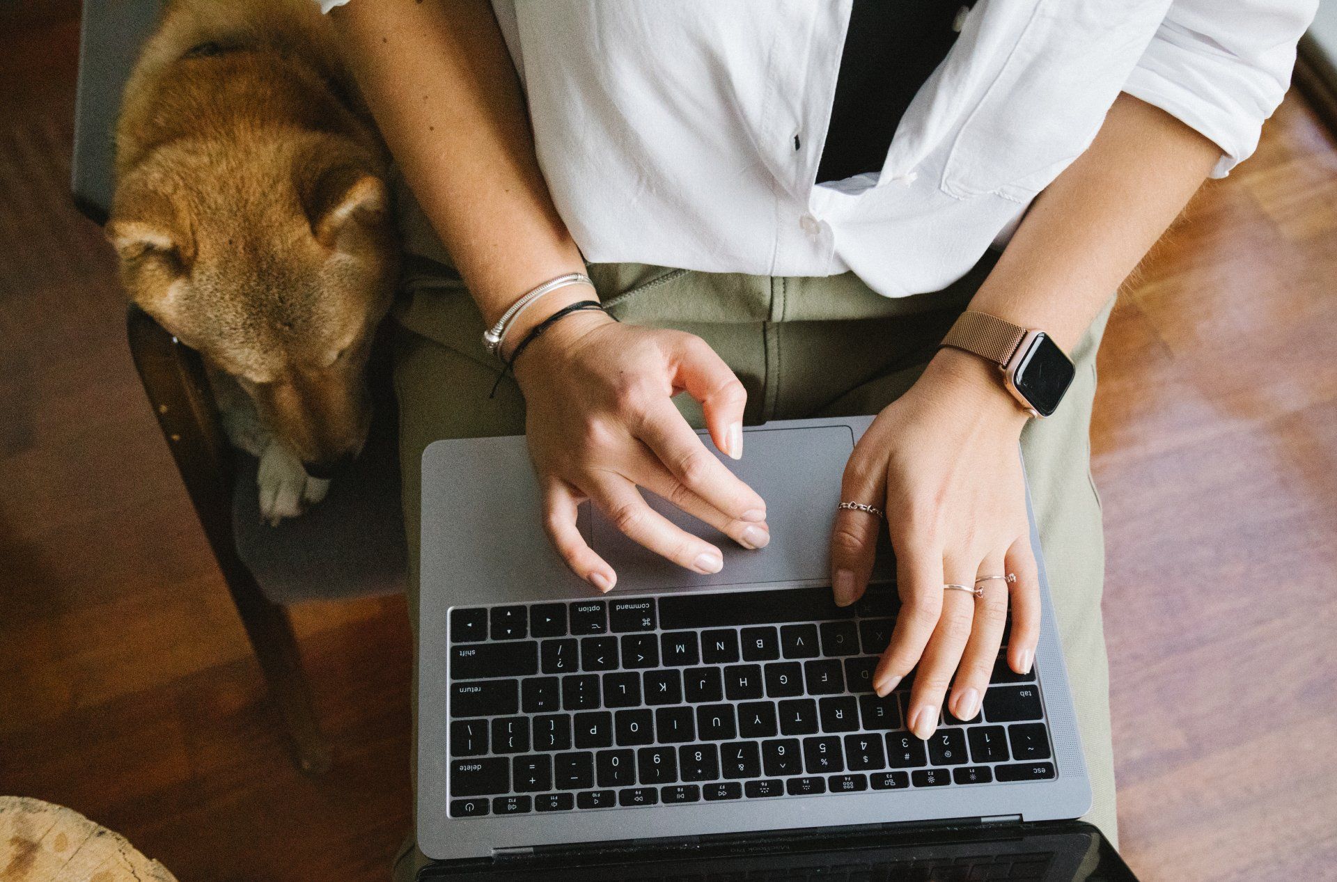 an aerial perspective of a person typing on a laptop