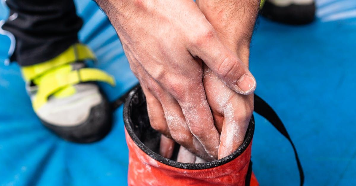 A close up of a person 's hands with chalk on them.