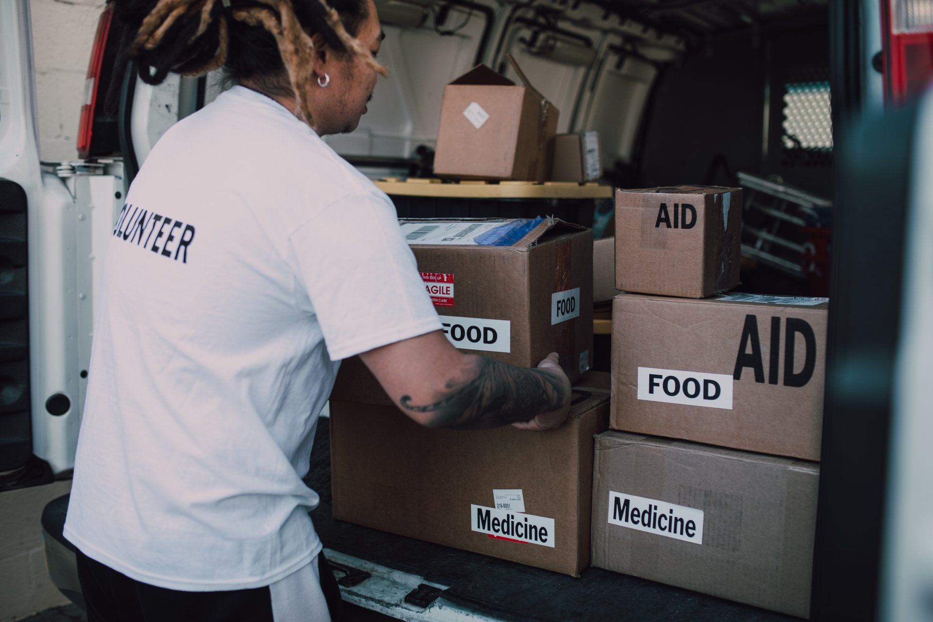 A volunteer unpacks boxes full of food at a Vermont food pantry