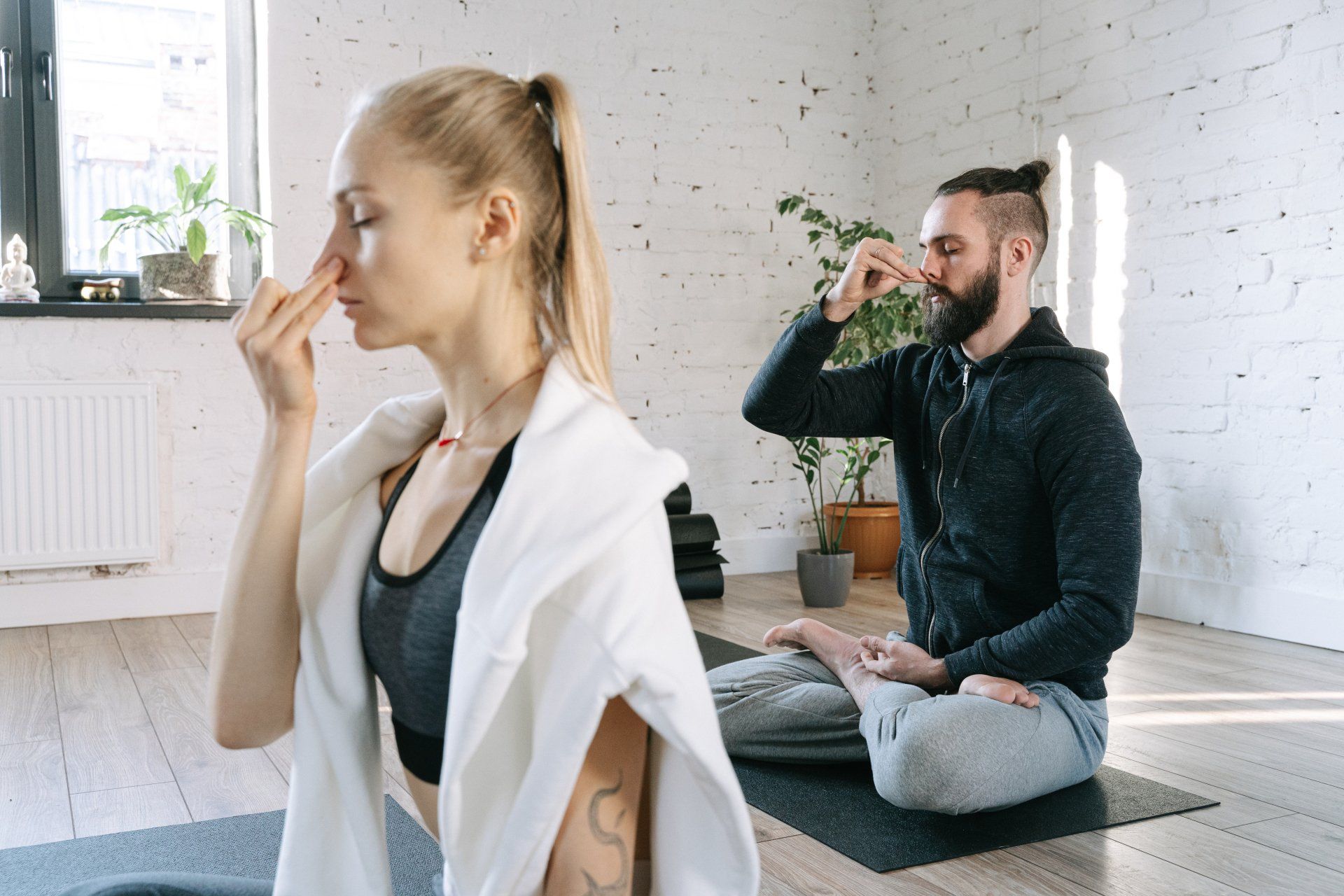 A man and a woman performing breathing exercises