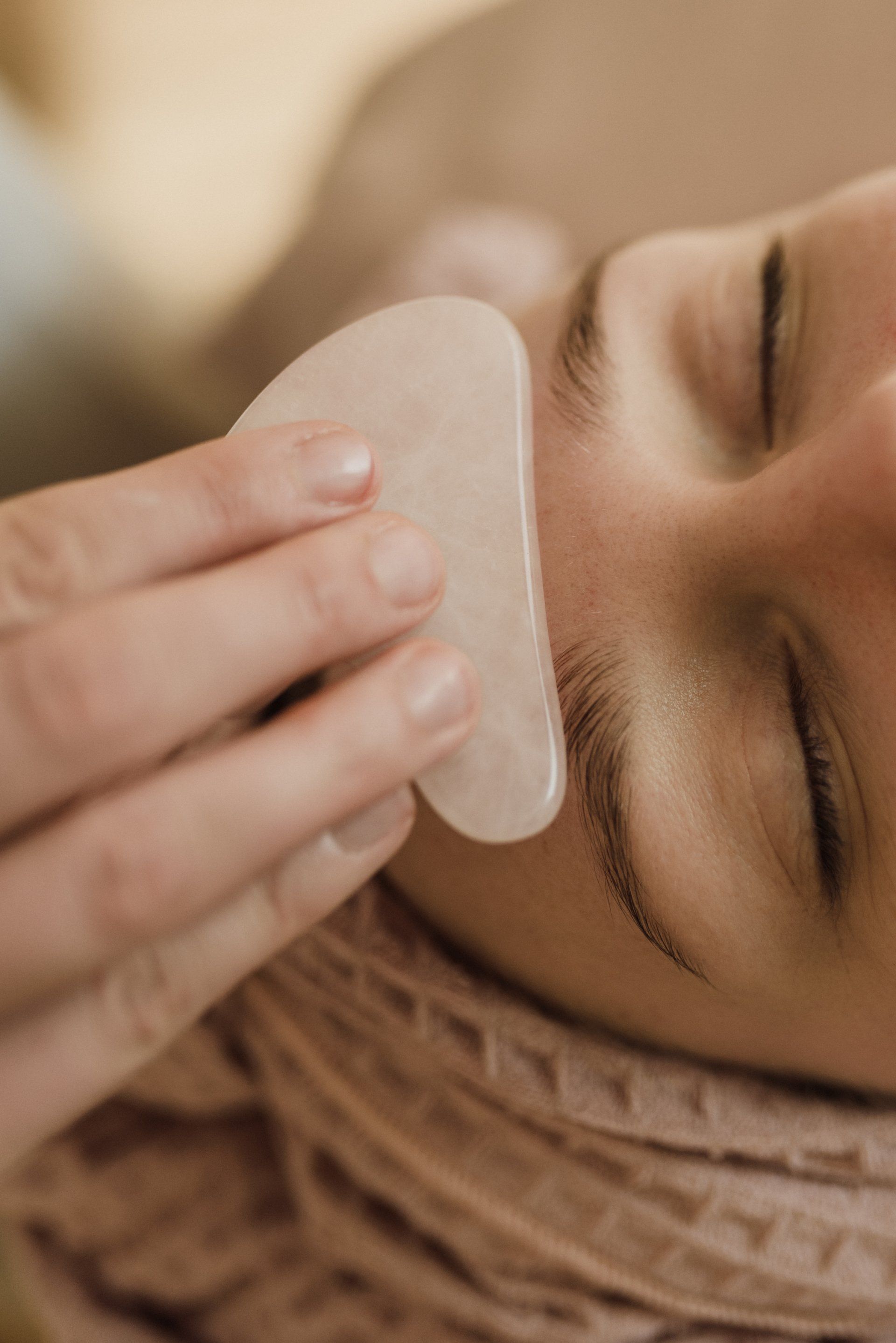 a woman with her eyes closed is getting her face scrubbed