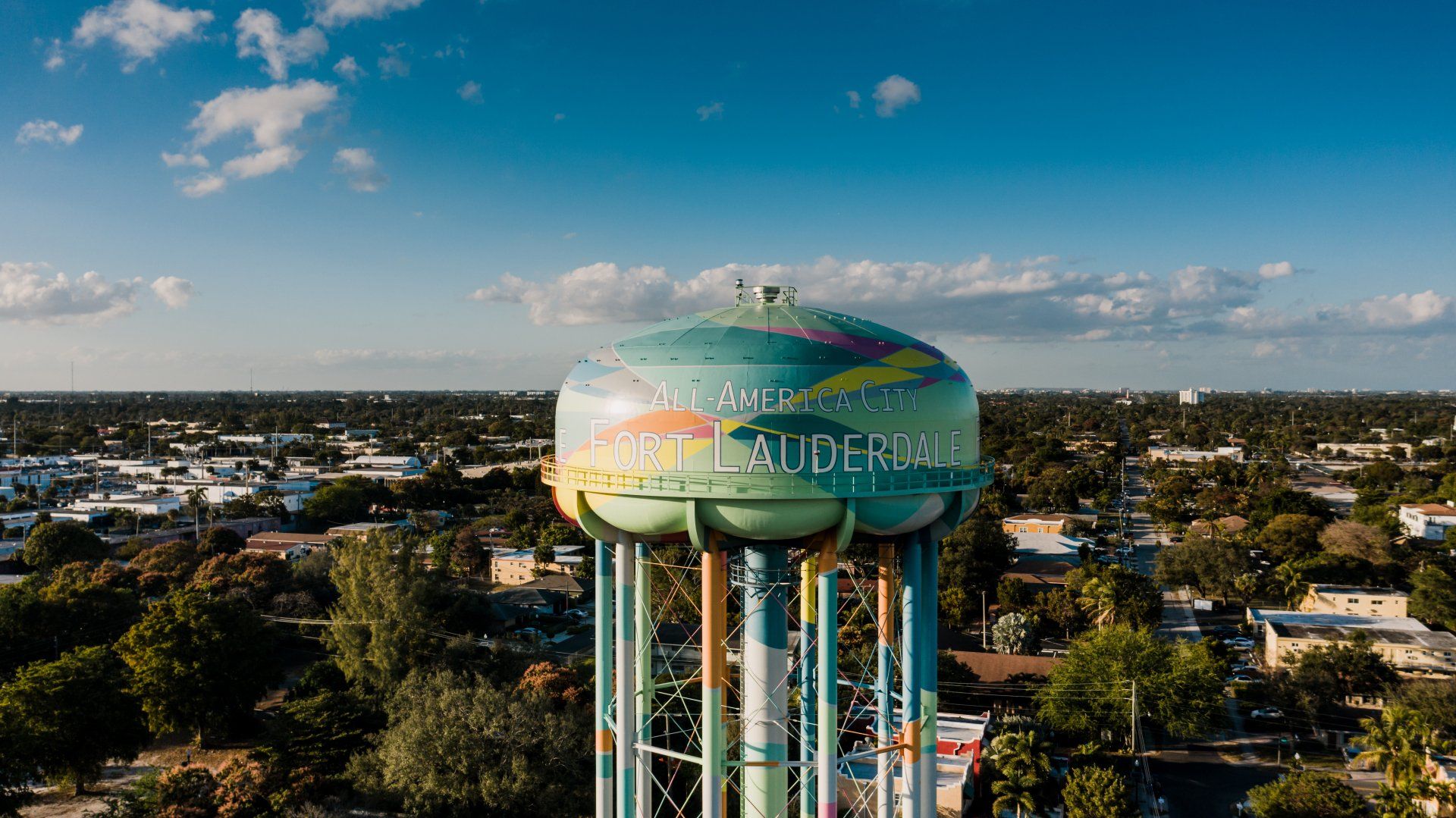 An aerial view of a water tower in the middle of a city.
