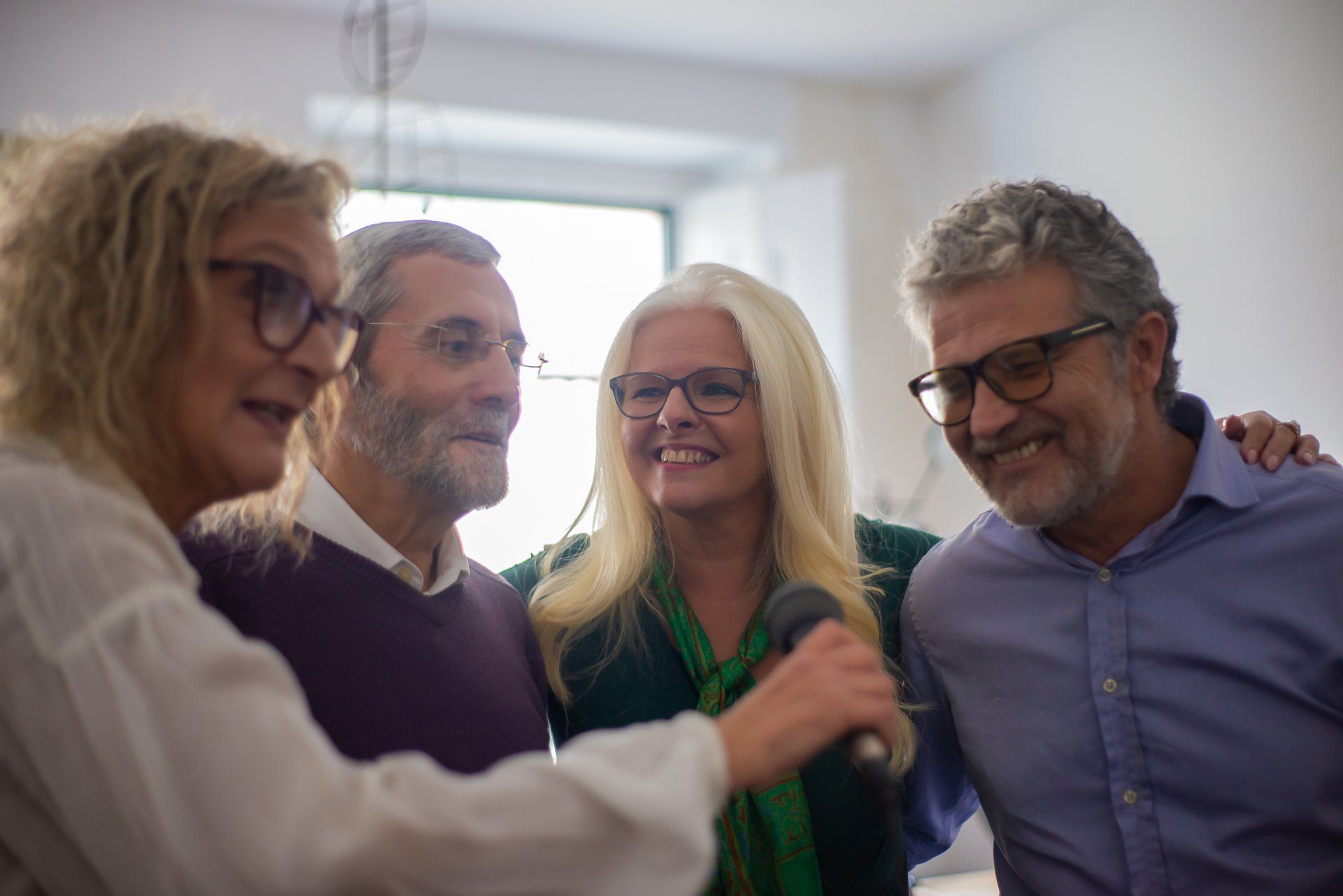 A group of people are standing next to each other in a room.
