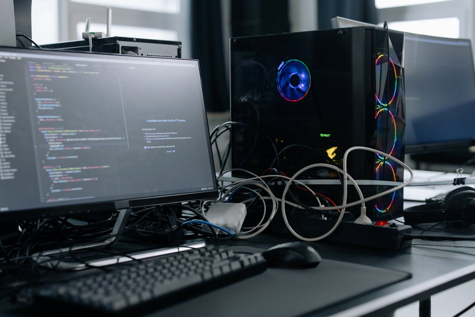 a computer is sitting on a desk next to a monitor and keyboard .