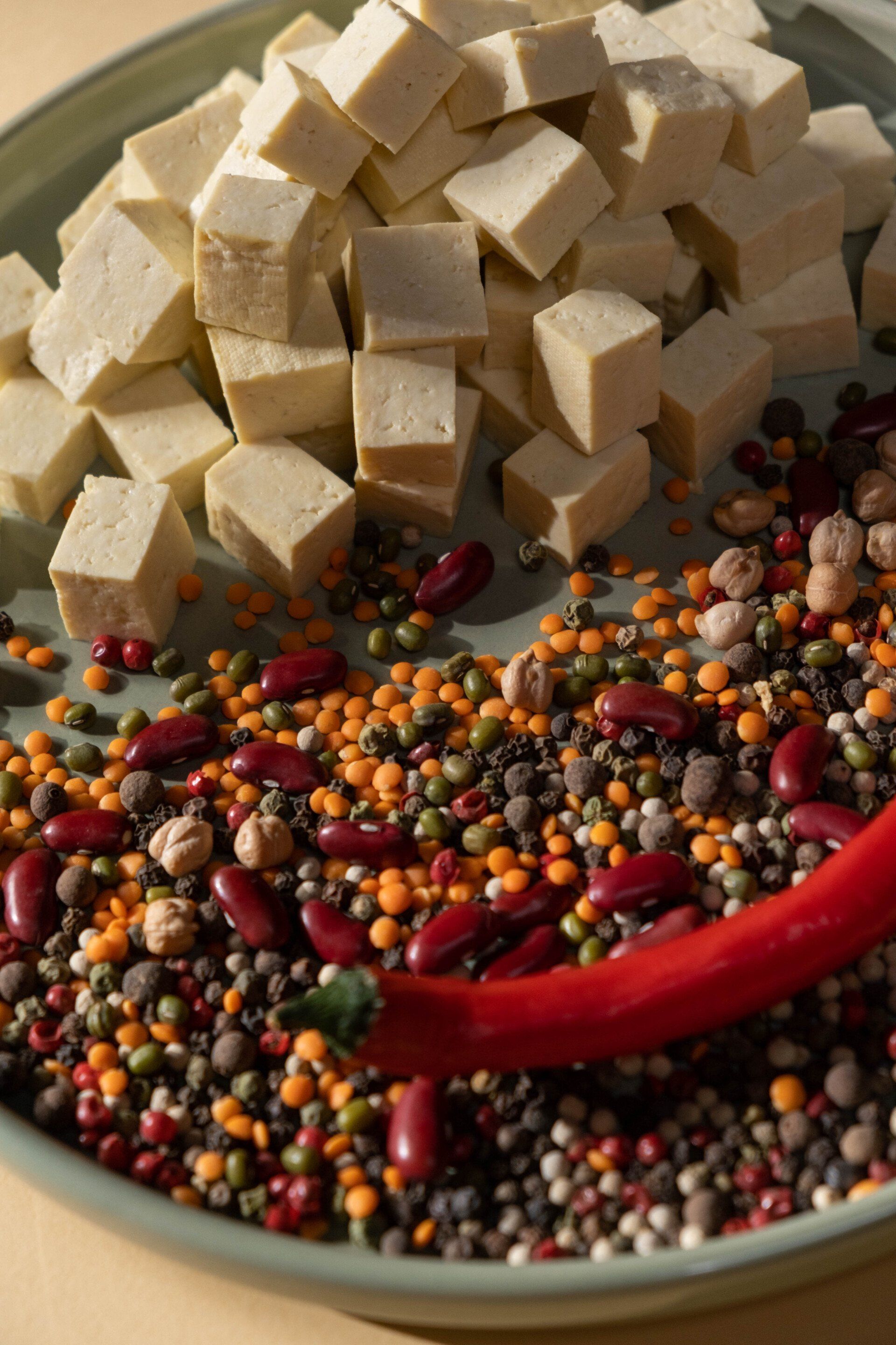 A plate of food with tofu and beans on it