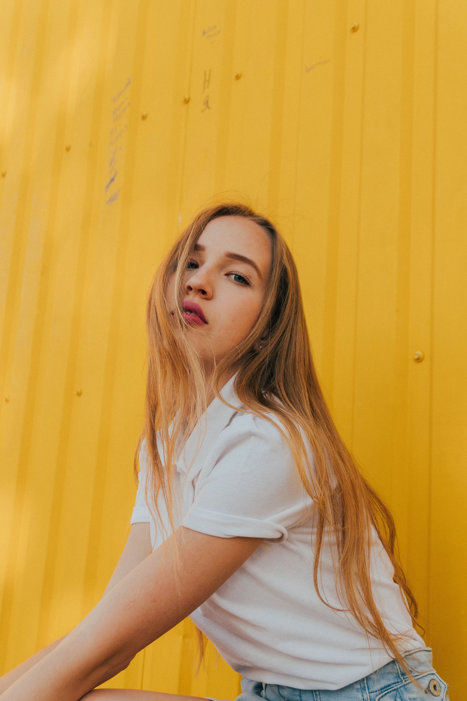 Woman in front of yellow background
