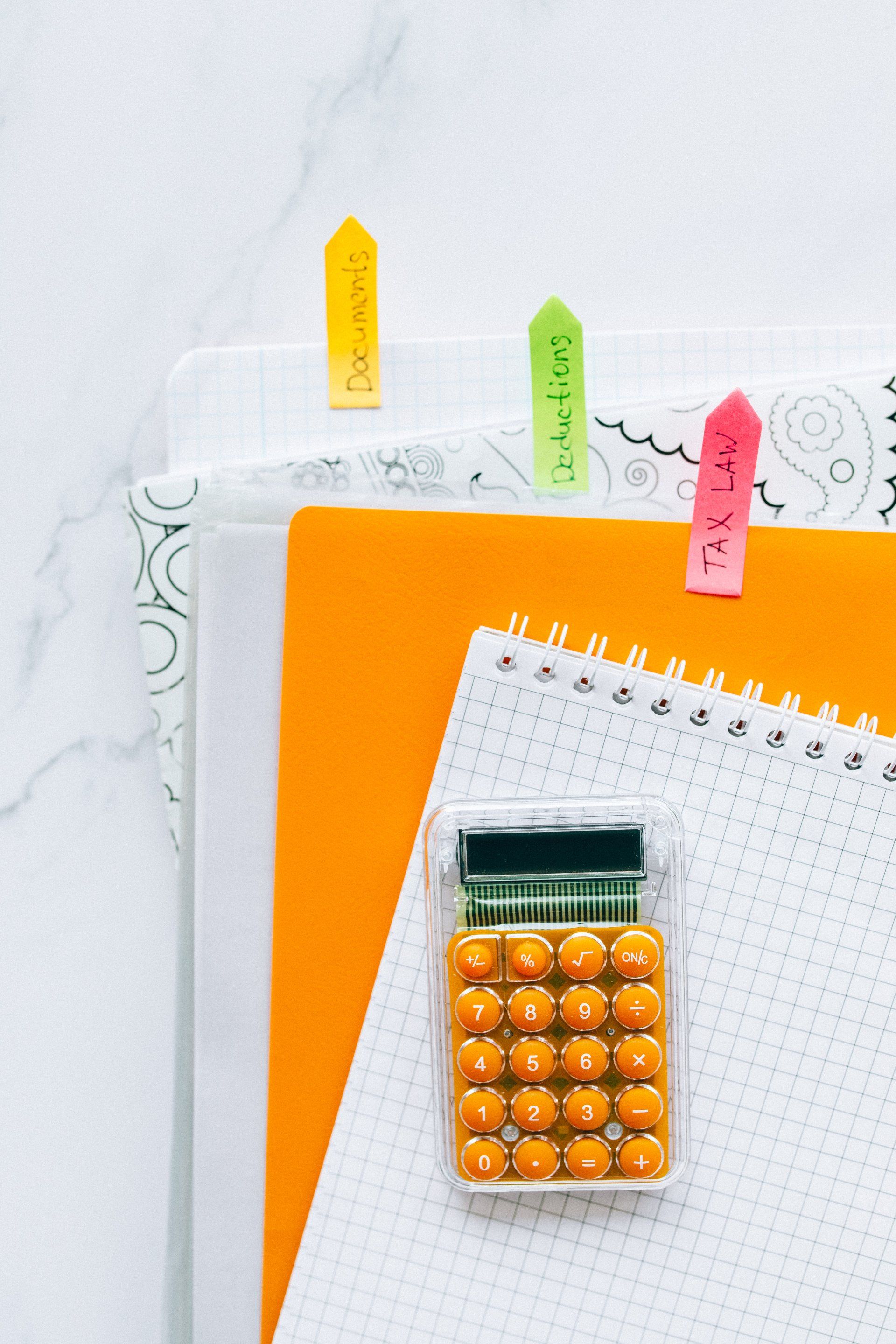 a calculator is sitting on top of a notebook .