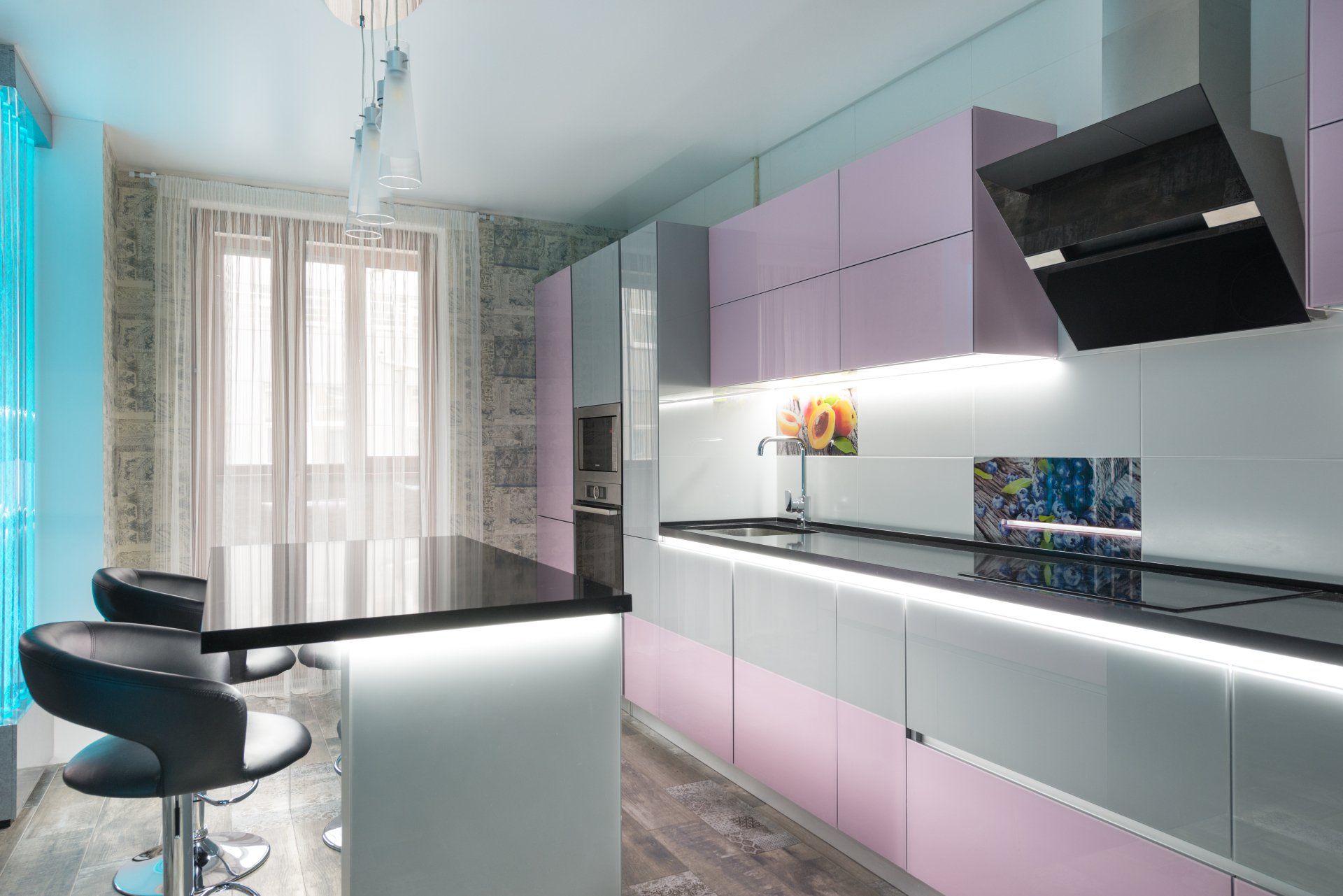 A kitchen with a dining table and chairs in it.