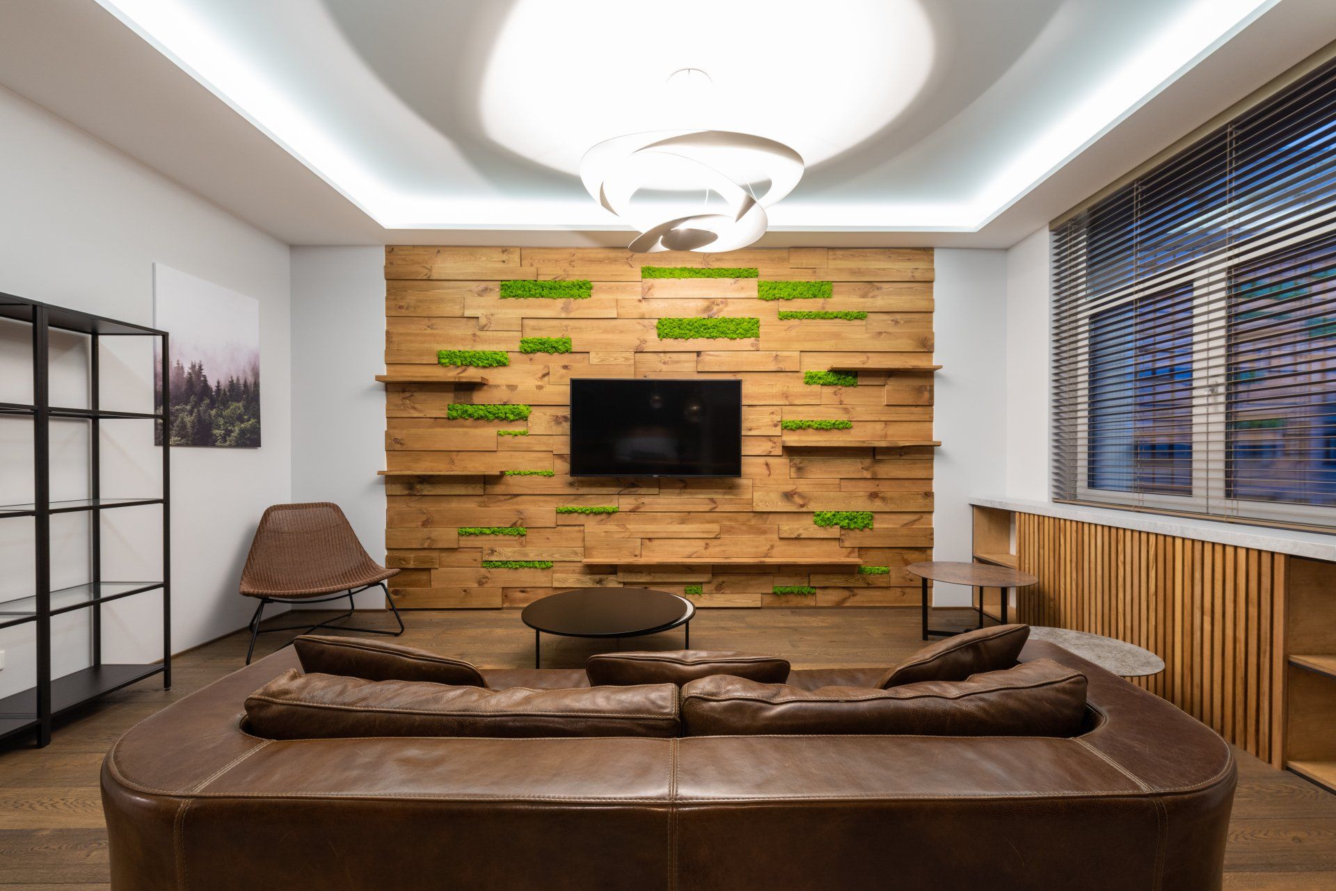 A living room with a wooden wall and a flat screen tv.