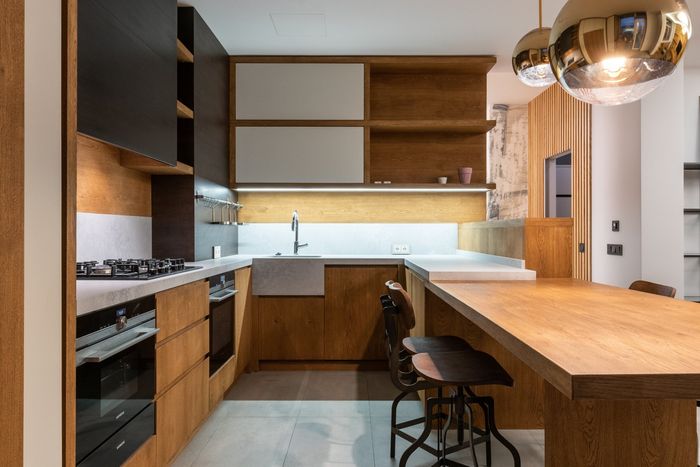 A kitchen with appliances, a sink , and a table.
