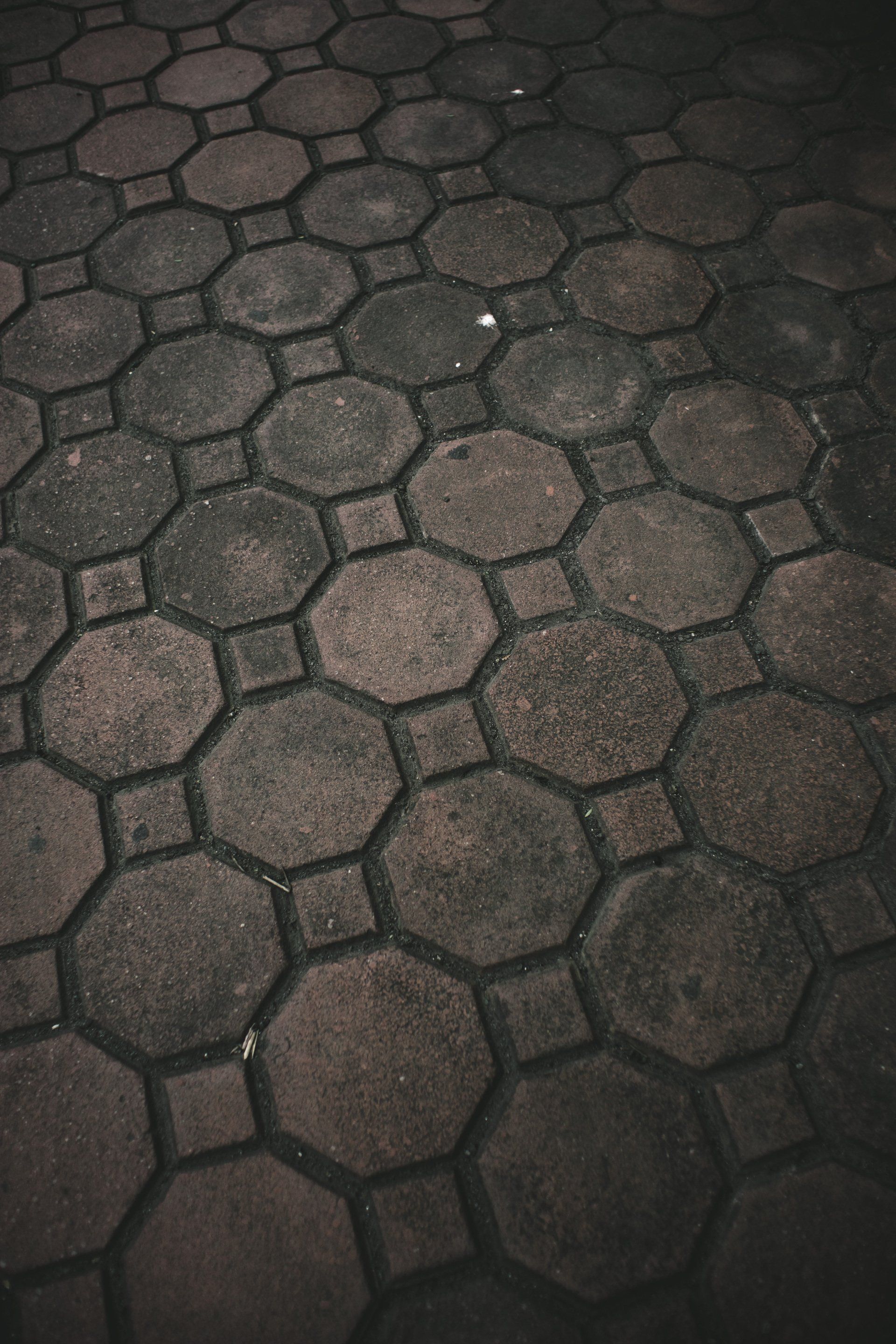 A close up of a brick floor with a hexagonal pattern.