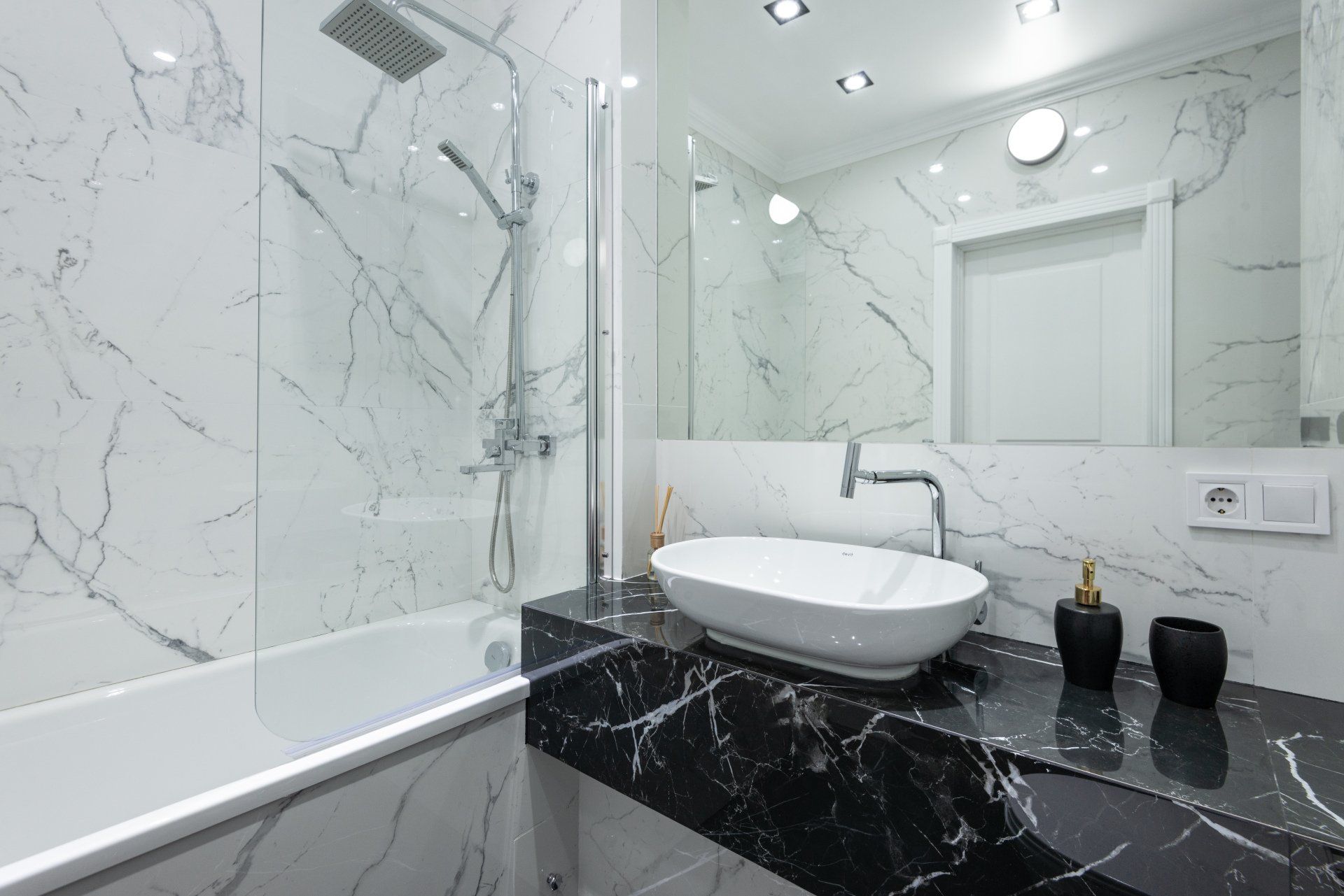 newly installed shower with glass, and large square shower head. new black countertops and modern large bowl sink