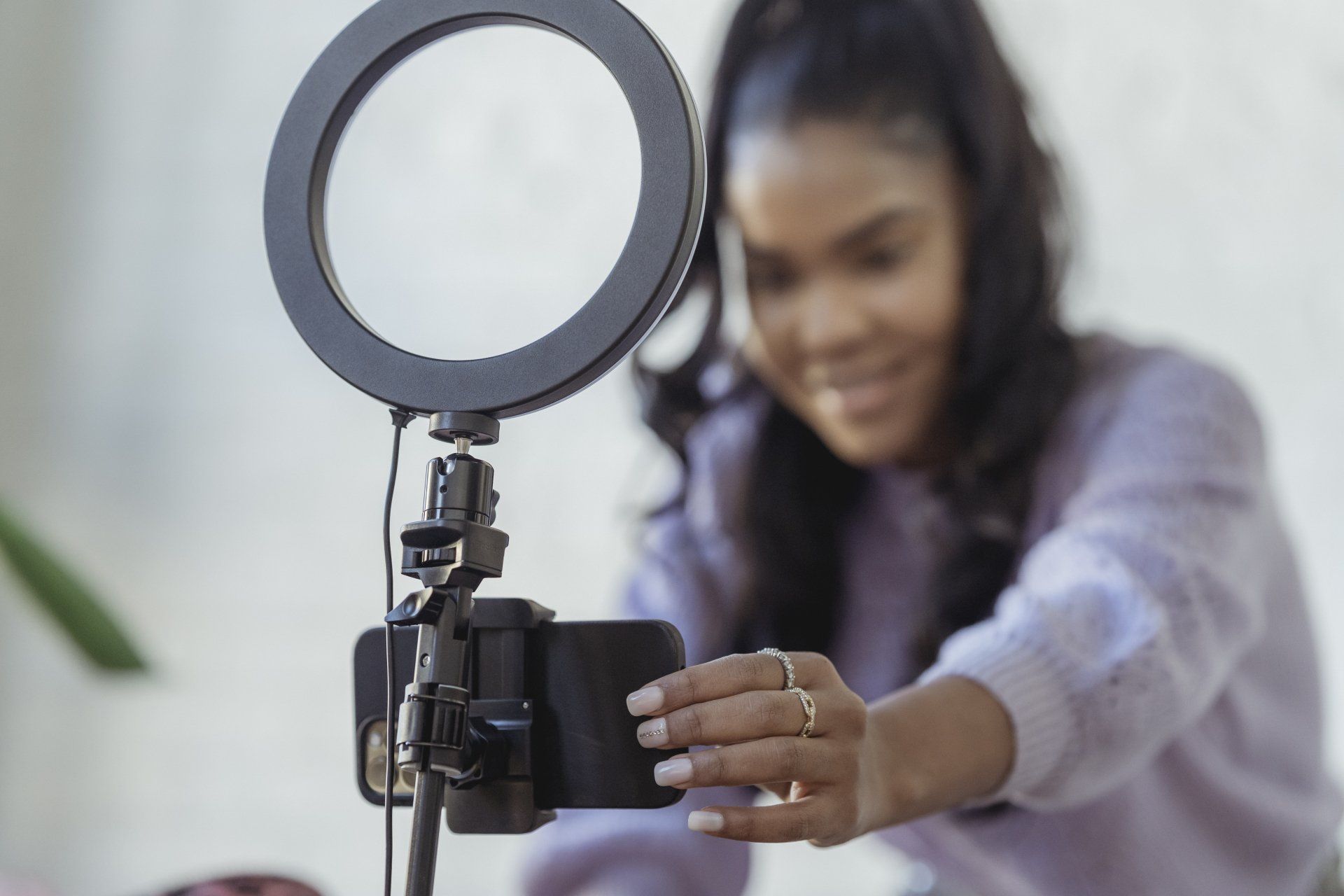 A woman is taking a picture of herself with a cell phone.