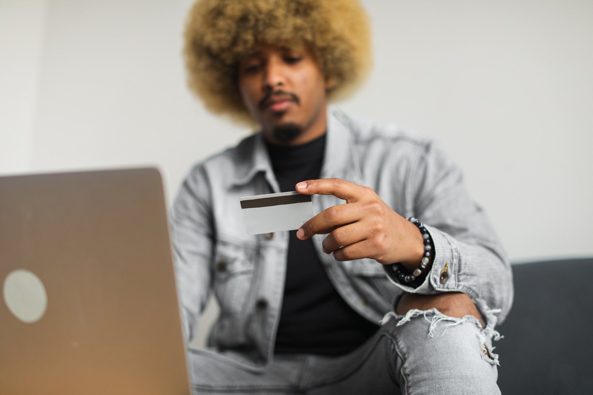 A man looking at his credit card.
