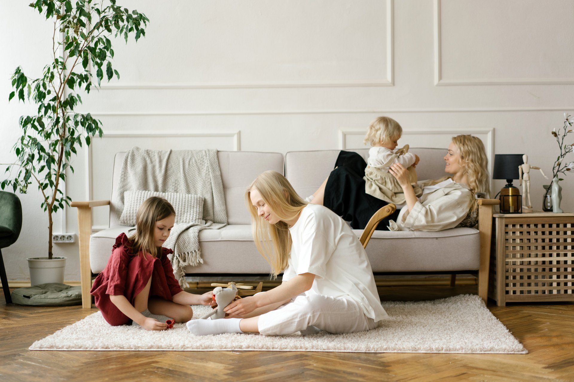 A mother and her little girl sat on the floor, sharing giggles as they played with colorful blocks