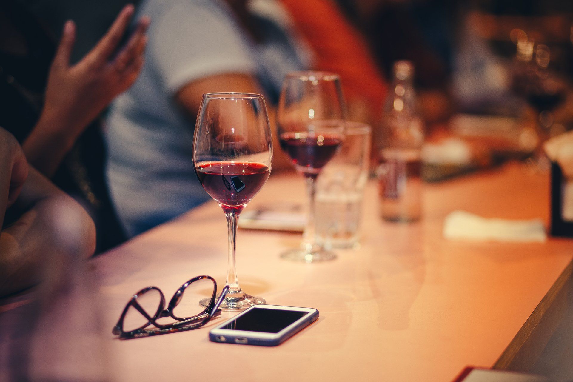 a row of wine glasses are lined up on a table .