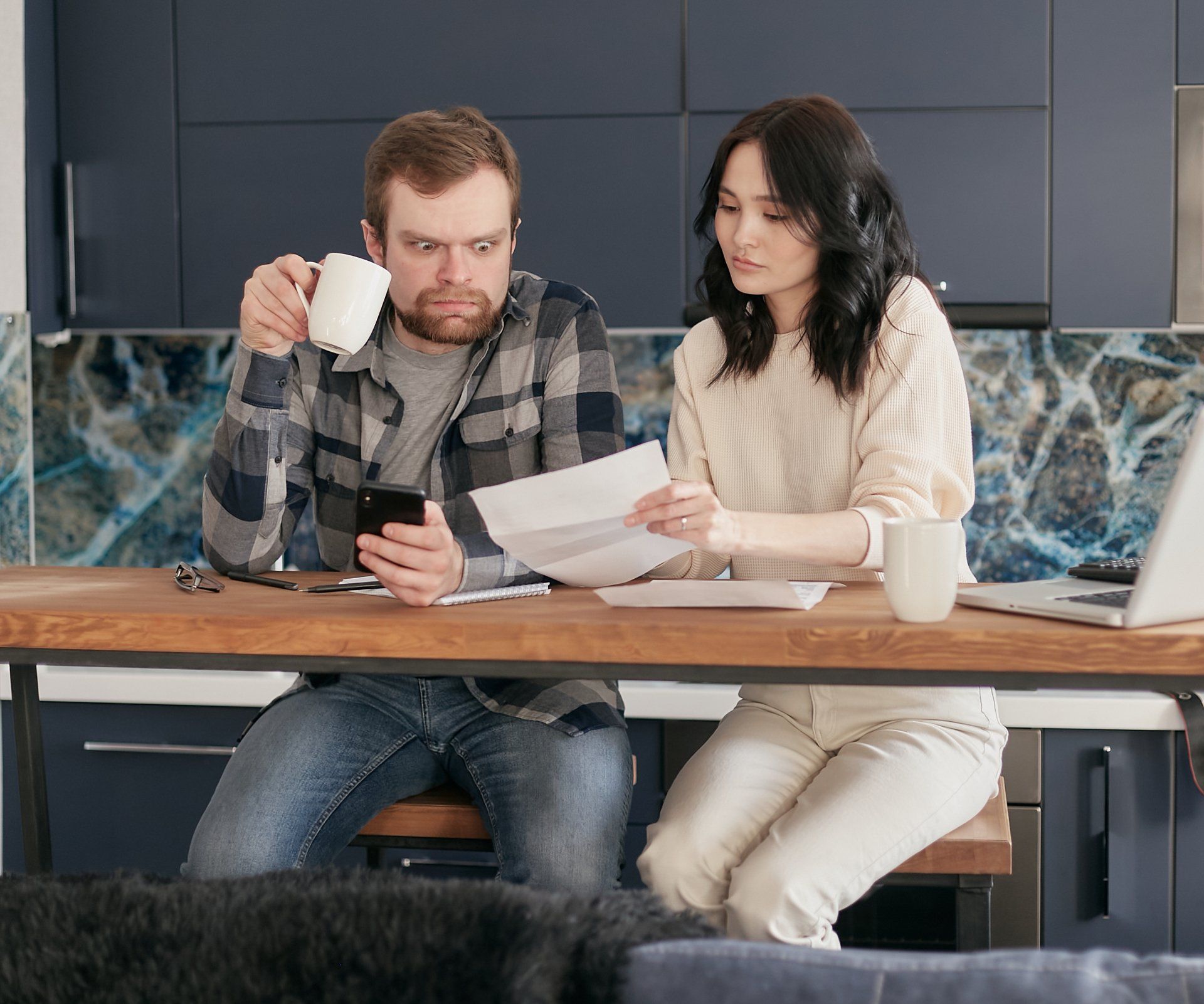 Man and Woman Discussing Financial Documents in Buffalo, NY