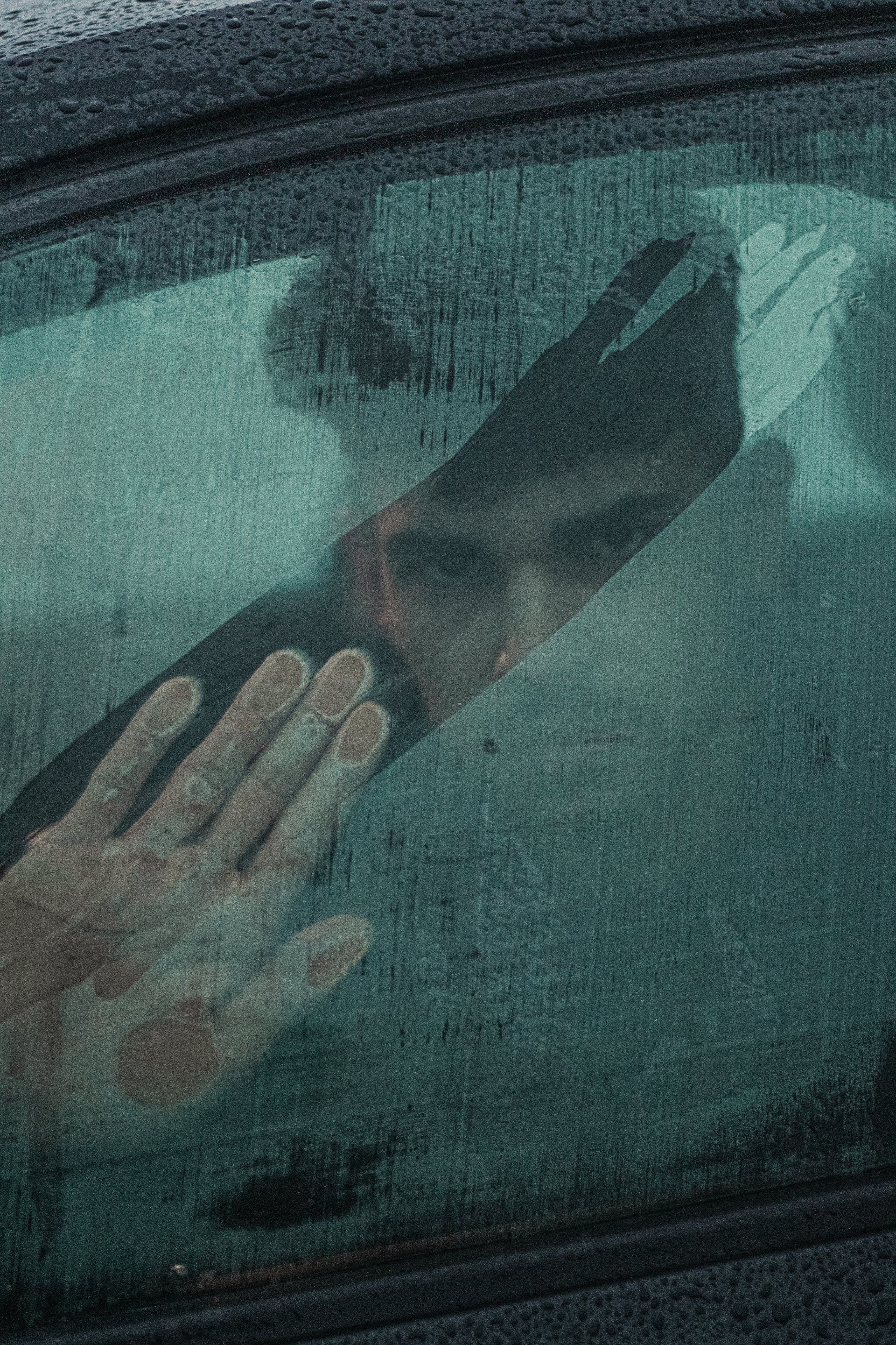 man cleaning windshield moisture man cleaning windshield moisture