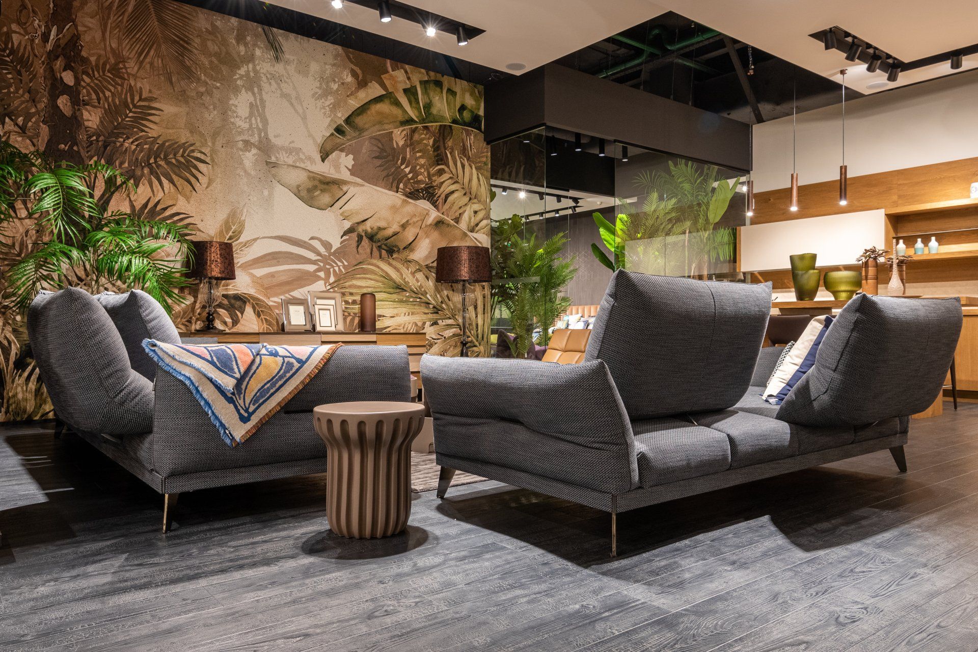 A living room with a couch and two chairs in it.