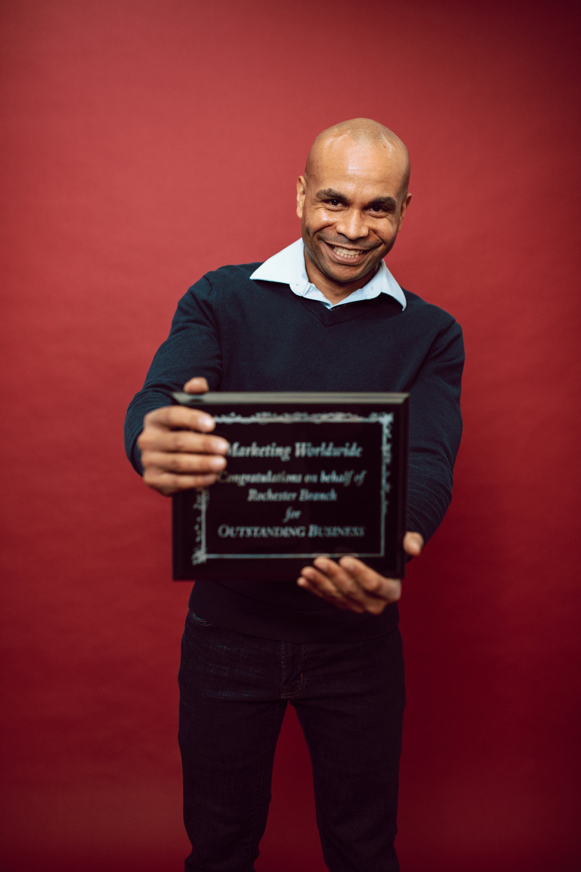 Employee holding an award