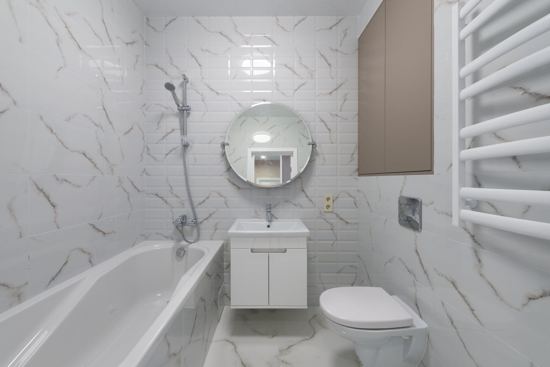 A bathroom with a bathtub , toilet , sink and mirror.
