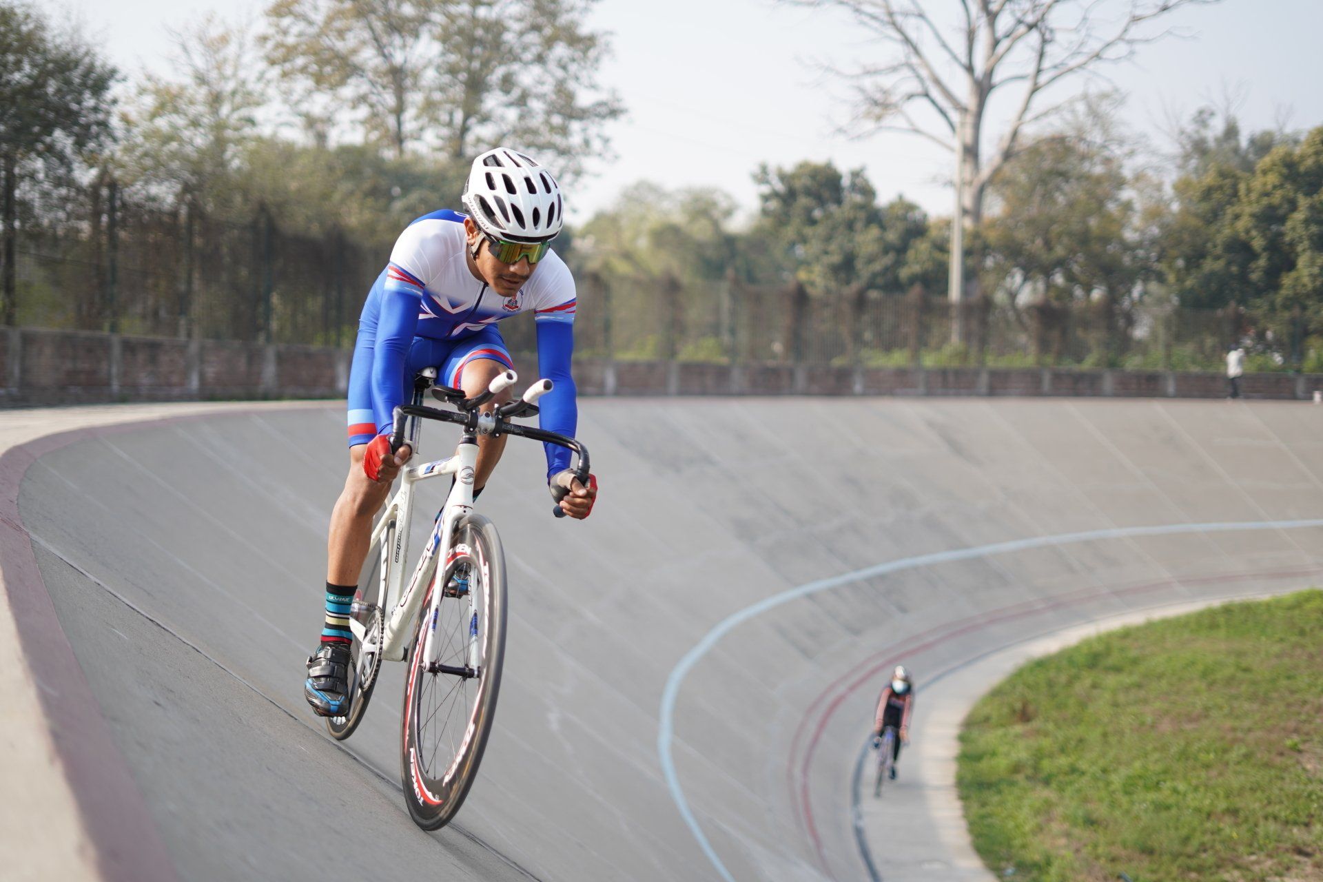 a man is riding a bike on a track .