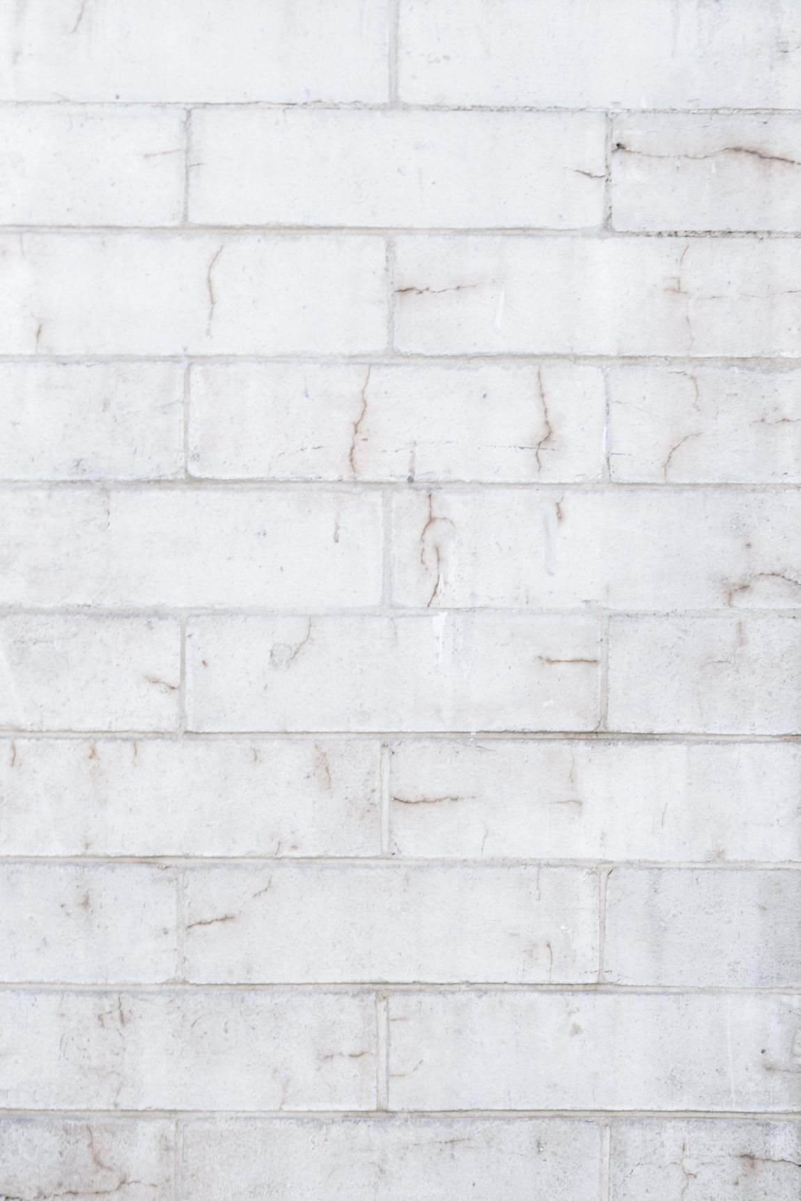 White brick wall with natural variations in color and pattern.