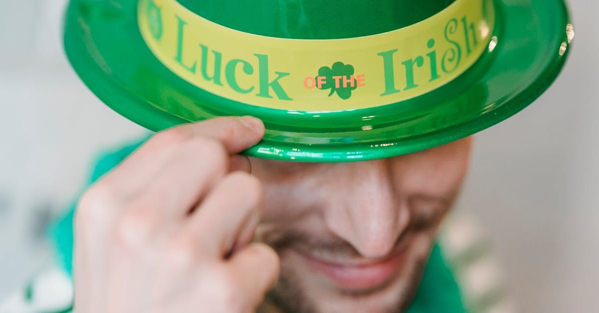 Man tipping a green hat with Luck of the Irish written on it