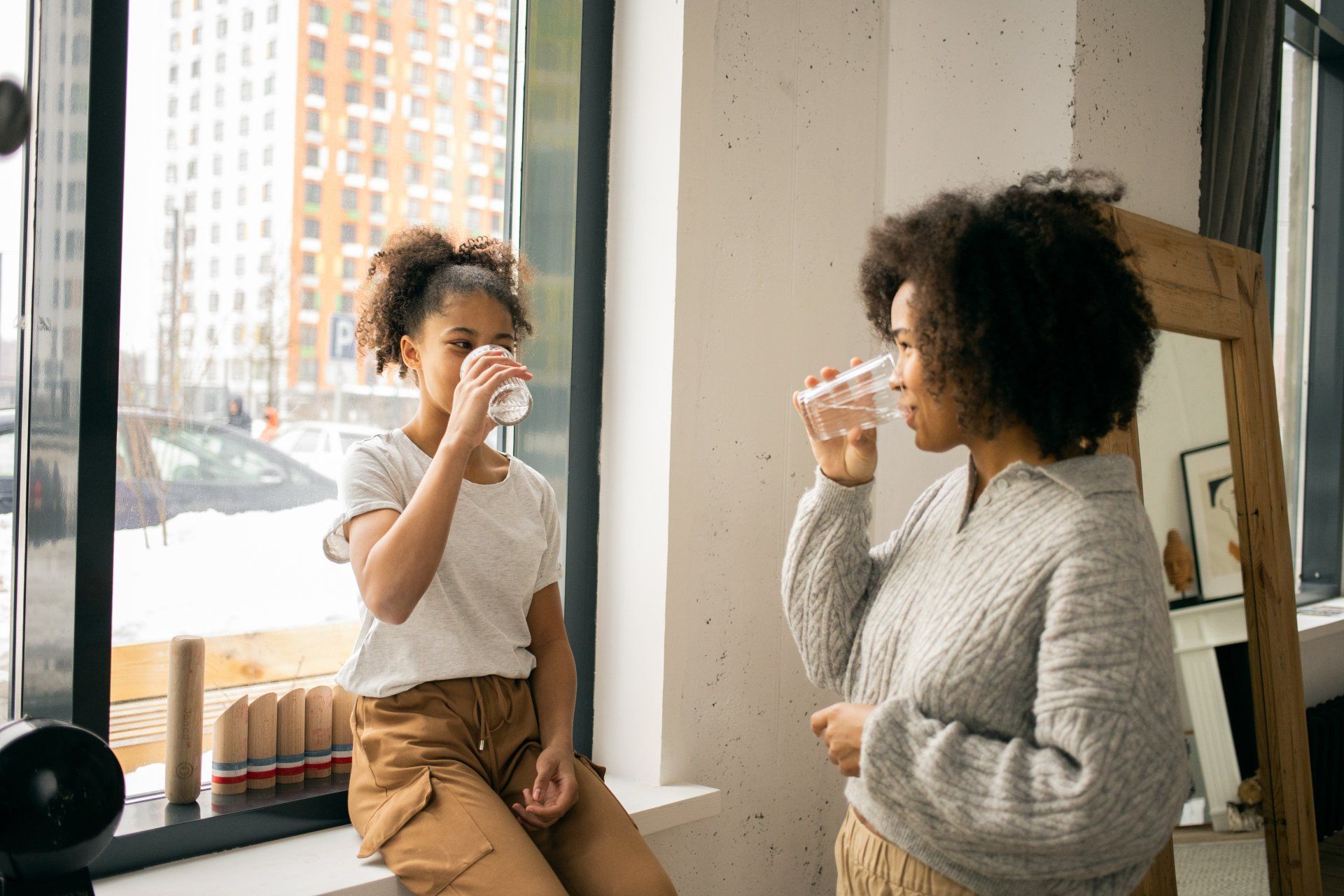 mom daughter drink water