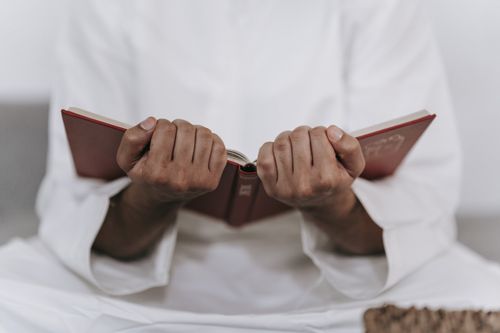 Online Ruqyah support session with a person holding the Qur’an during online ruqyah session