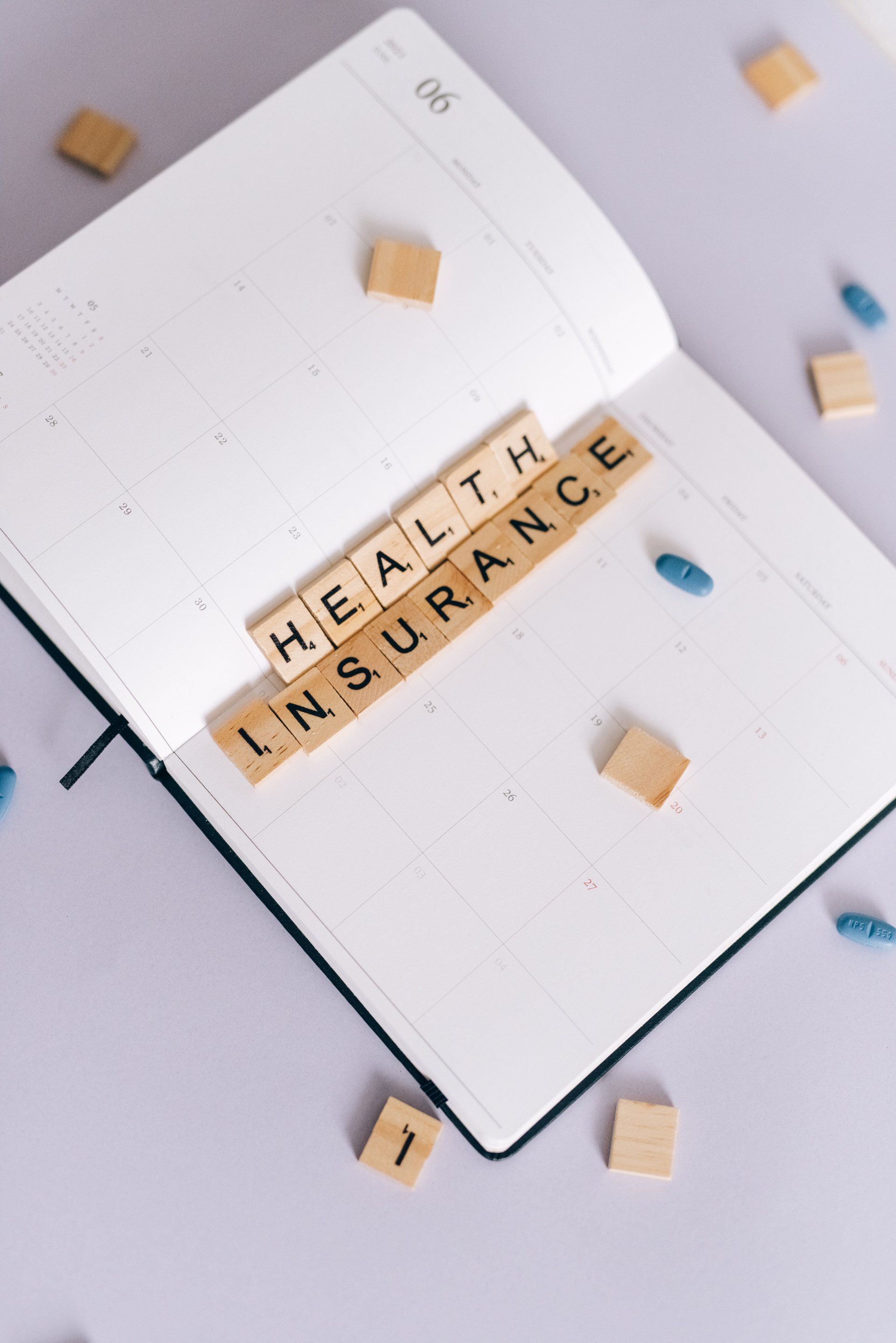 A notebook is open to a page that says health insurance