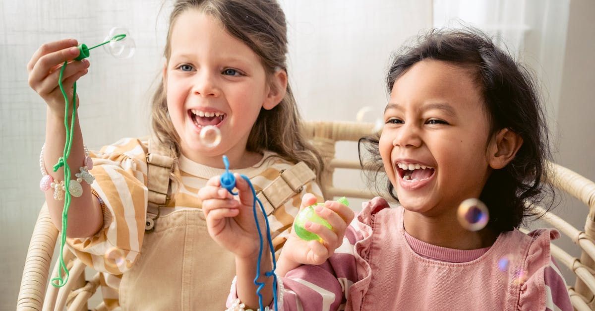 Two young girls blowing bubbles. Two young girls blowing bubbles.