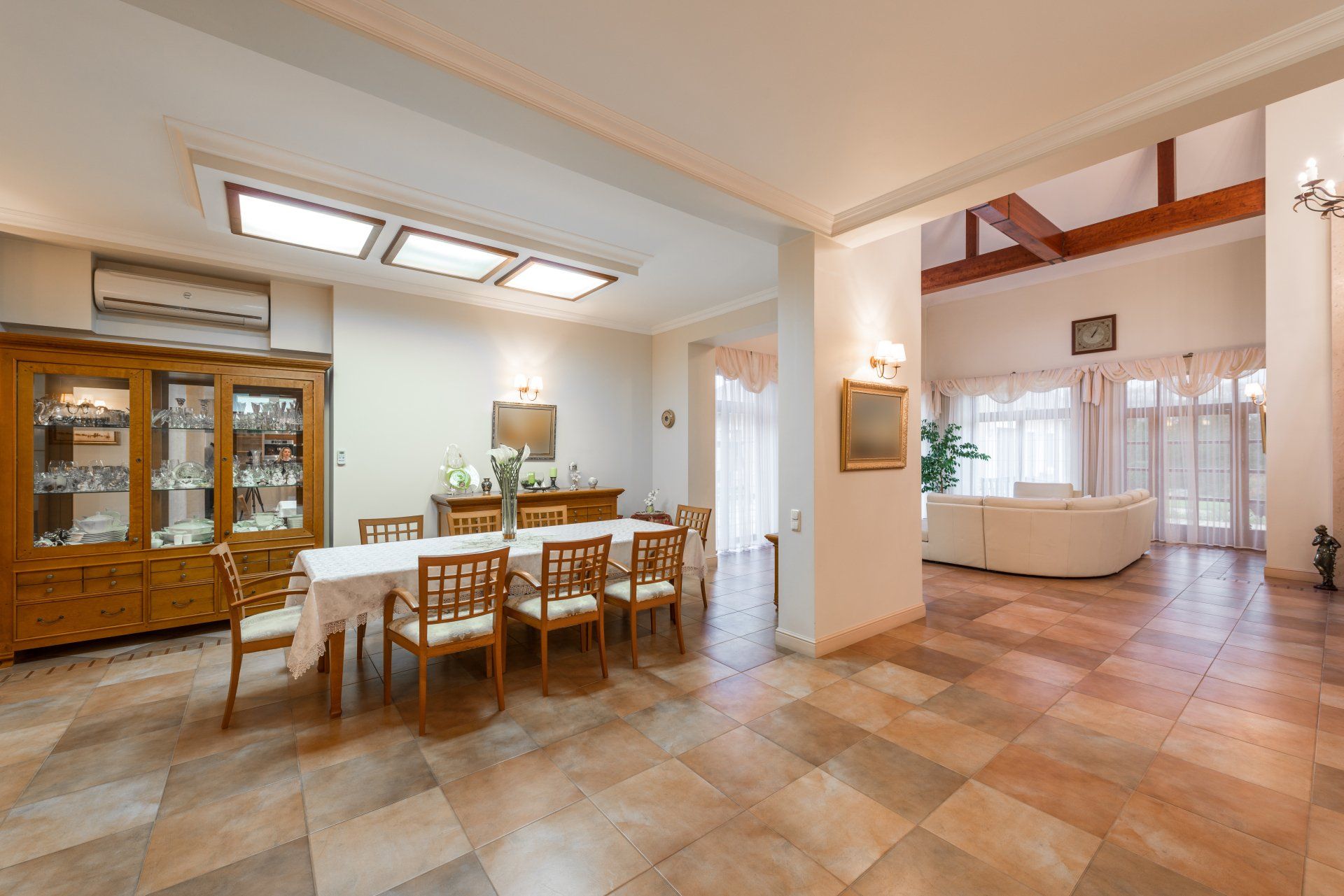 A large dining room with a table and chairs in a house.